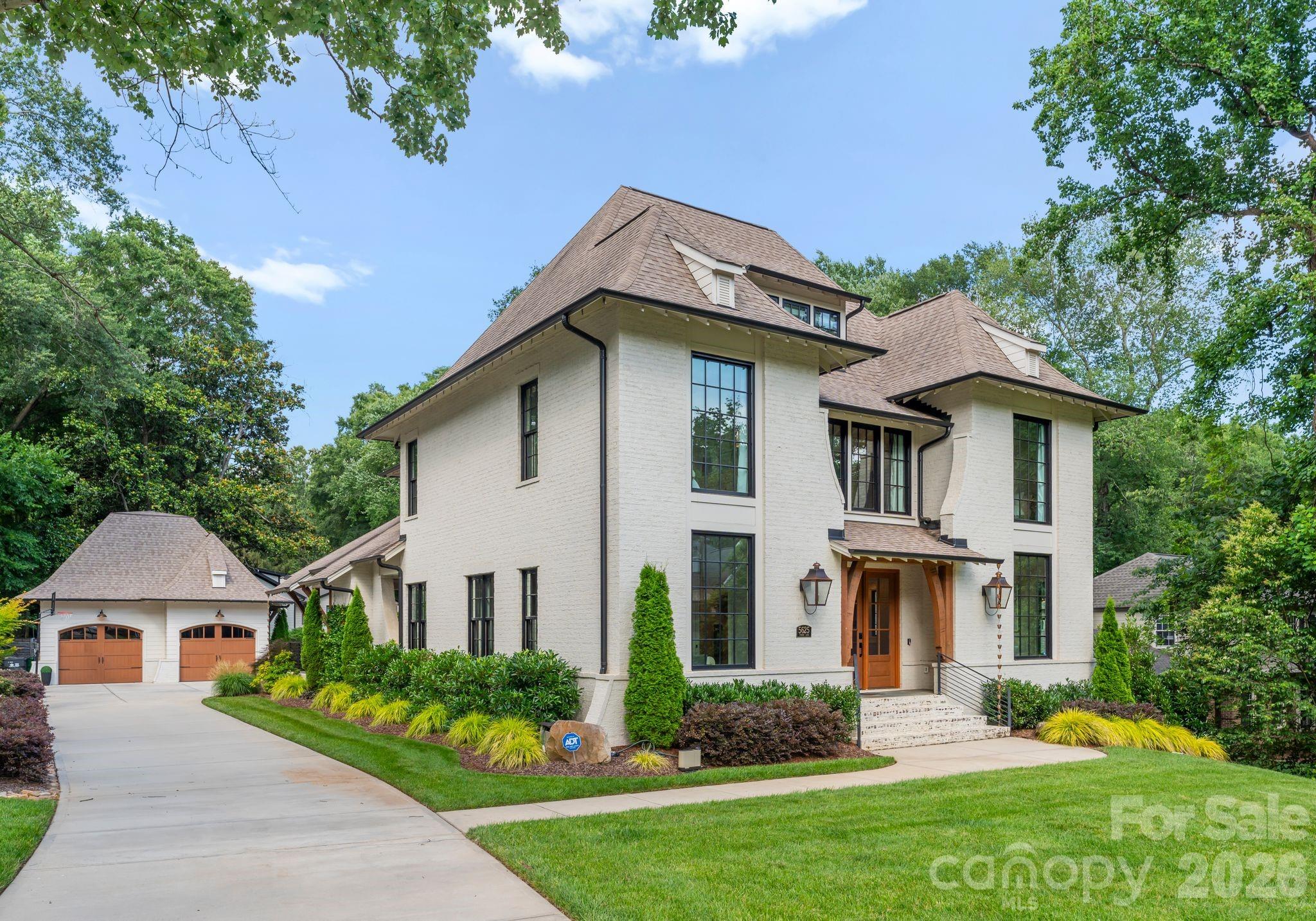 Tucked away on a private half-acre homesite in Charlotte’s coveted Mammoth Oaks community, 5625 Timber Lane is an exceptional custom home by Pike Properties that effortlessly blends timeless architecture with refined, modern living. With 5 bedrooms and 4.5 baths, every space has been thoughtfully designed to balance comfort, functionality, and understated luxury. Inside, an open and light-filled floor plan welcomes you with soaring ceilings and rich hardwood floors throughout. The kitchen serves as the centerpiece of the home, featuring high-end appliances, a walk-in pantry, and an oversized island that flows into the dining area and inviting family room anchored by a fireplace. The main level also includes a dedicated study, ideal for a home office or quiet retreat, along with a spacious primary suite designed for privacy and relaxation with a spa-inspired bath.
The second level features three generously sized bedrooms, including one ensuite with its own private full bath, while the remaining two bedrooms are connected by a well-appointed Jack-and-Jill bathroom. A flexible loft-style space provides the perfect area for a homework station, lounge, or additional living space. The third level adds even more versatility with a private guest suite and bonus area—ideal for extended family, overnight guests, or a private retreat. Outdoors, a covered porch with a fireplace creates a welcoming space for year-round enjoyment while overlooking a beautifully landscaped backyard framed by mature trees that offer both privacy and room to play. Located just minutes from SouthPark, this home offers an exceptional combination of thoughtful design, everyday comfort, and one of Charlotte’s most desirable locations