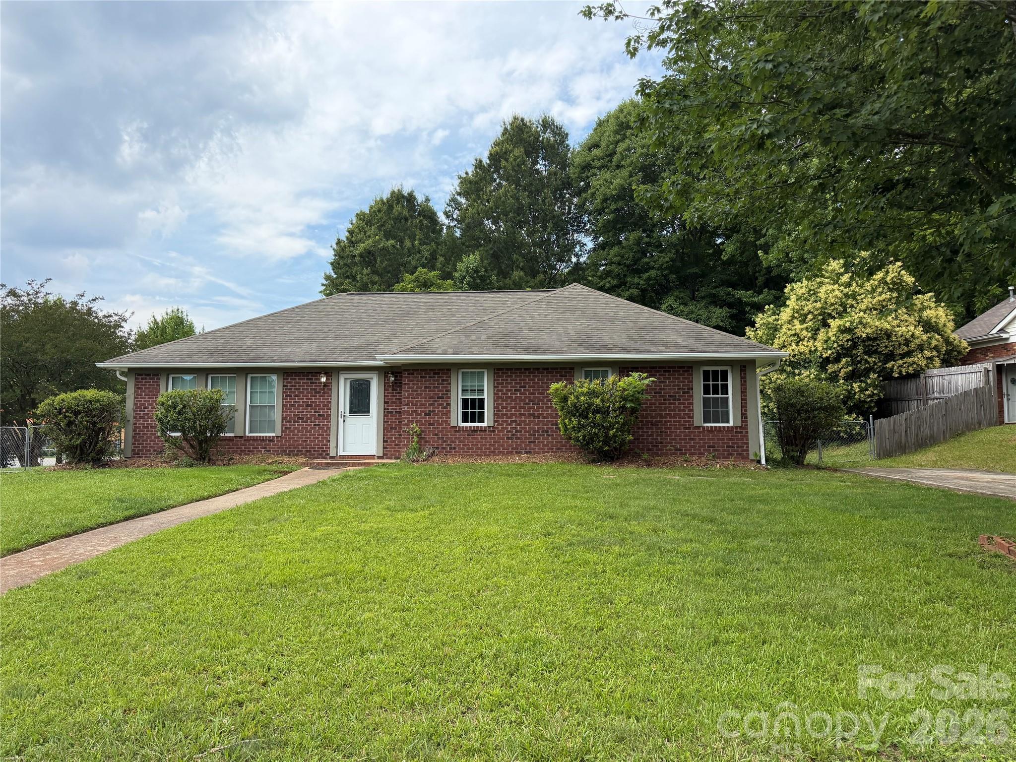 Opportunity awaits with this charming 4-bedroom, 2-bath brick home situated on a spacious corner lot in Charlotte. Full of character and solidly built, this property is ready for a new owner to bring their vision and transform it into something truly special.

With four bedrooms, two full baths, and a functional layout, this home offers plenty of space to create the home you've always wanted. The large fenced backyard provides room for outdoor entertaining, gardening, pets, or future enhancements, while the corner lot adds privacy and curb appeal. Practical features abound, including two separate driveways, a one-car garage carport, and two storage outbuildings, offering exceptional flexibility for vehicles, tools, hobbies, or additional storage.

Whether you're a homeowner looking to customize a property to your style or an investor searching for a promising renovation opportunity, this hidden gem is packed with potential. Homes with this much space, storage, and lot size don't come along often.

Bring your imagination and discover the possibilities. With a little updating, this property could truly shine!