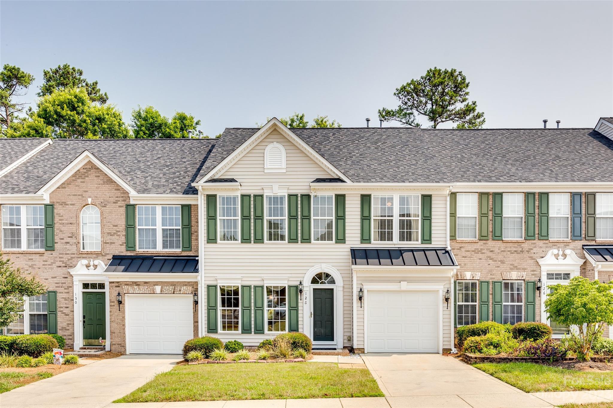 Welcome to 128 Hightide Drive. This 2 story townhouse is located in the highly desirable, lakefront community of Sunset Point. The main floor offers a semi-open concept, making it perfect for entertaining. The kitchen features a breakfast bar and opens to a dining area and to the living room. The living room is spacious has a gas fireplace. Upstairs you will find the primary bedroom and ensuite with dual vanities and an updated walk in shower. The back patio is large, private and covered, making it a great place to relax and grill out. In Sunset Point, the HOA covers  the lawn maintenance, exterior maintenance(pressure washing) and trash/recycling service. You have access to a community pool, private beach area, and a private picnic area. This community is conveniently located, just minutes to shopping, dining, medical facilities and I-77. No City Taxes.