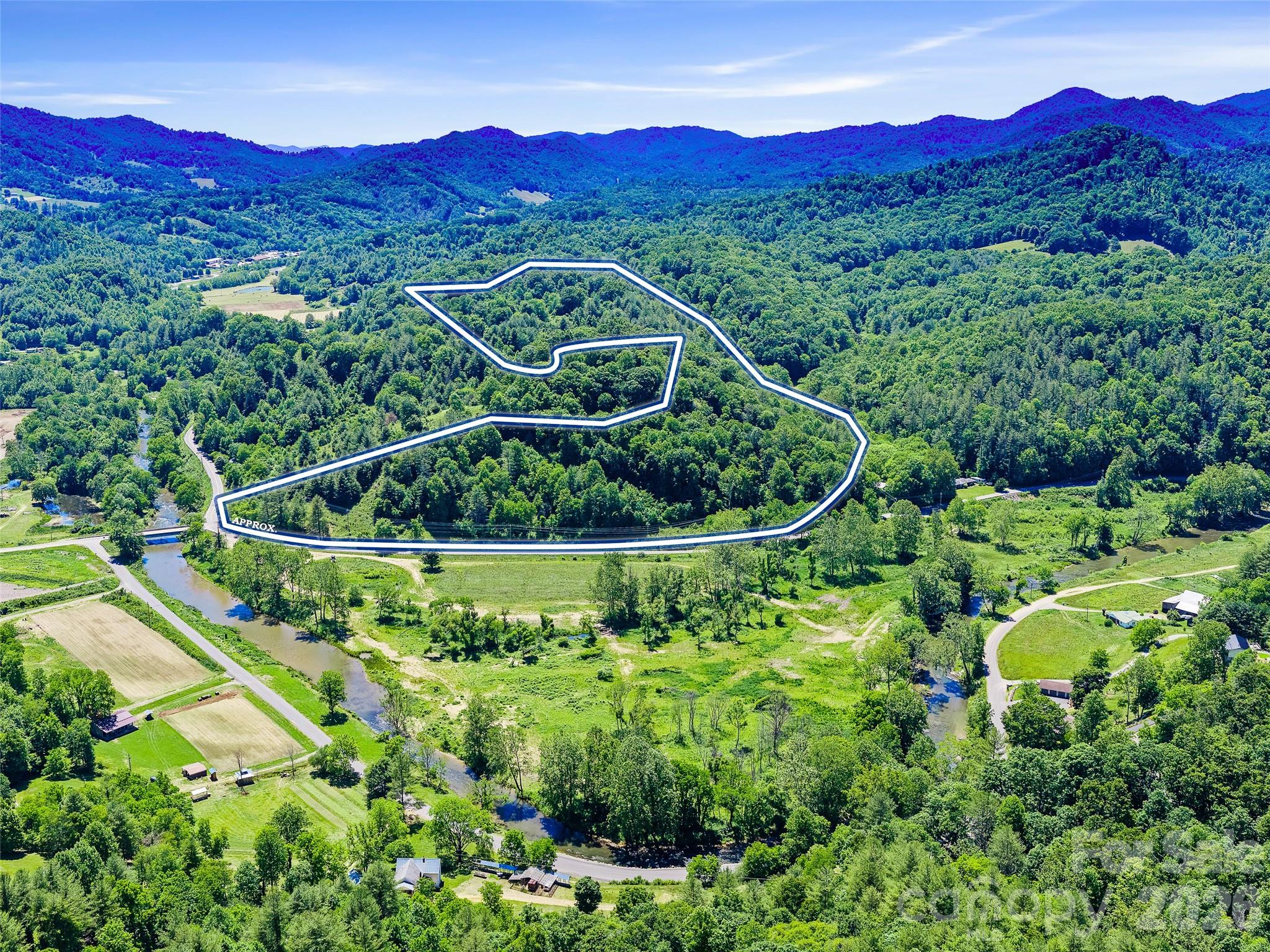 Tucked above the Cane River valley just 10 minutes from Burnsville, this approximately 20± acre wooded mountain parcel delivers long-range views, seclusion, and that authentic Western North Carolina character buyers are after. A winding drive leads through mature hardwoods into multiple natural clearing areas offering sweeping, layered views of the surrounding Blue Ridge peaks in multiple directions. The varied topography creates several potential building site candidates, giving a future owner flexibility in placement. Whether you're envisioning your forever home, a weekend retreat, or a private mountain sanctuary, this land offers genuine mountain appeal and long-term value in one of Yancey County's most scenic corridors. This parcel is available individually or as part of a larger 38± acre offering. See MLS #4390605 for the combined listing and MLS #4390580 for the adjoining 18± acre river parcel.