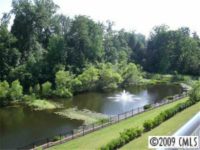 Impeccable, open, spacious and airy condo in Ballantyne.  Gated and secure building.  Backs up to the gorgeous pond, and short walk to the pool.  Enjoy this carefree lifestyle and ability to walk to the neighborhood shopping, restaurants, theater, YMCA & night life.  Split 3 bedroom plan.  Master suite has large walk in closet, and spacious glamour bath.  The secondary bedrooms have been secluded.  Upgraded kitchen, Laundry room included W/D.  Light carpets and hardwoods. Great-Room fireplace.