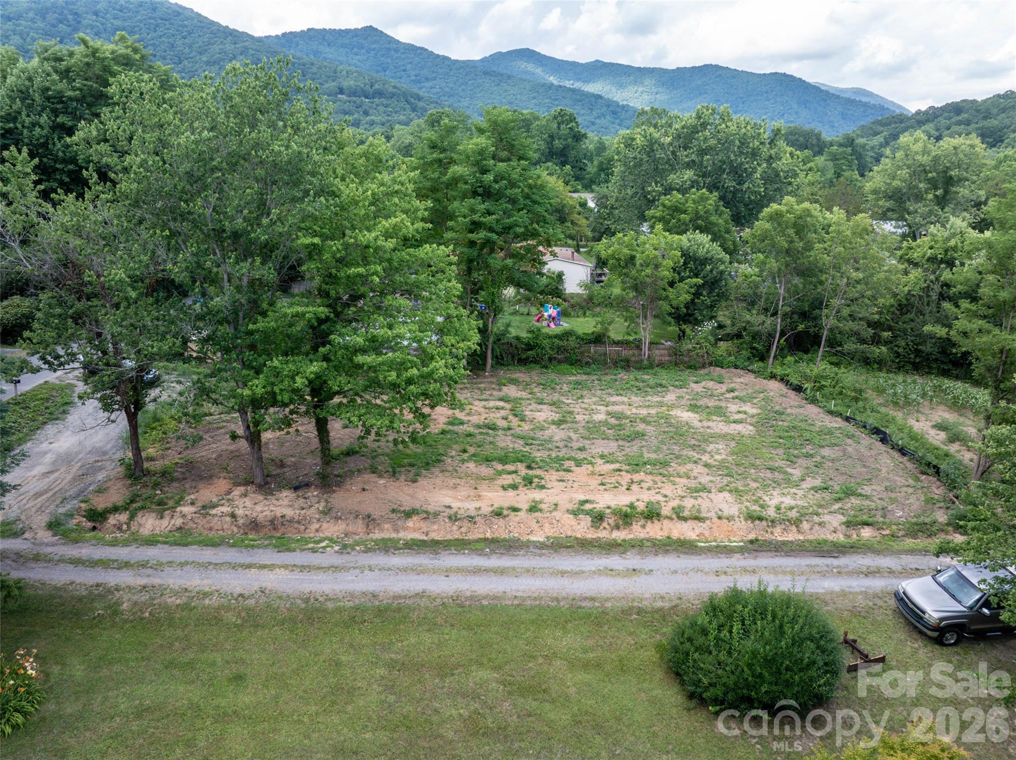 A rare find in the heart of Black Mountain — this level, 0.23-acre homesite has already had the hard work done for you. The former mobile home has been removed, leaving a clean, buildable lot ready for its next chapter.

Existing utility connections remain in place, offering a possible head start on water, sewer, and electric hookups for a site-built, modular, or doublewide home. The level grade makes for easier site prep, and the quiet residential setting puts you just minutes from downtown Black Mountain's shops and restaurants, with Montreat's trails close by for hiking and outdoor recreation.

A flexible option for investors, builders, or anyone looking to place a new home in a convenient mountain-town location — without the cost or hassle of demolition.

Buyer to verify zoning, utility hookup status, and any applicable permitting with Town of Black Mountain and Buncombe County.