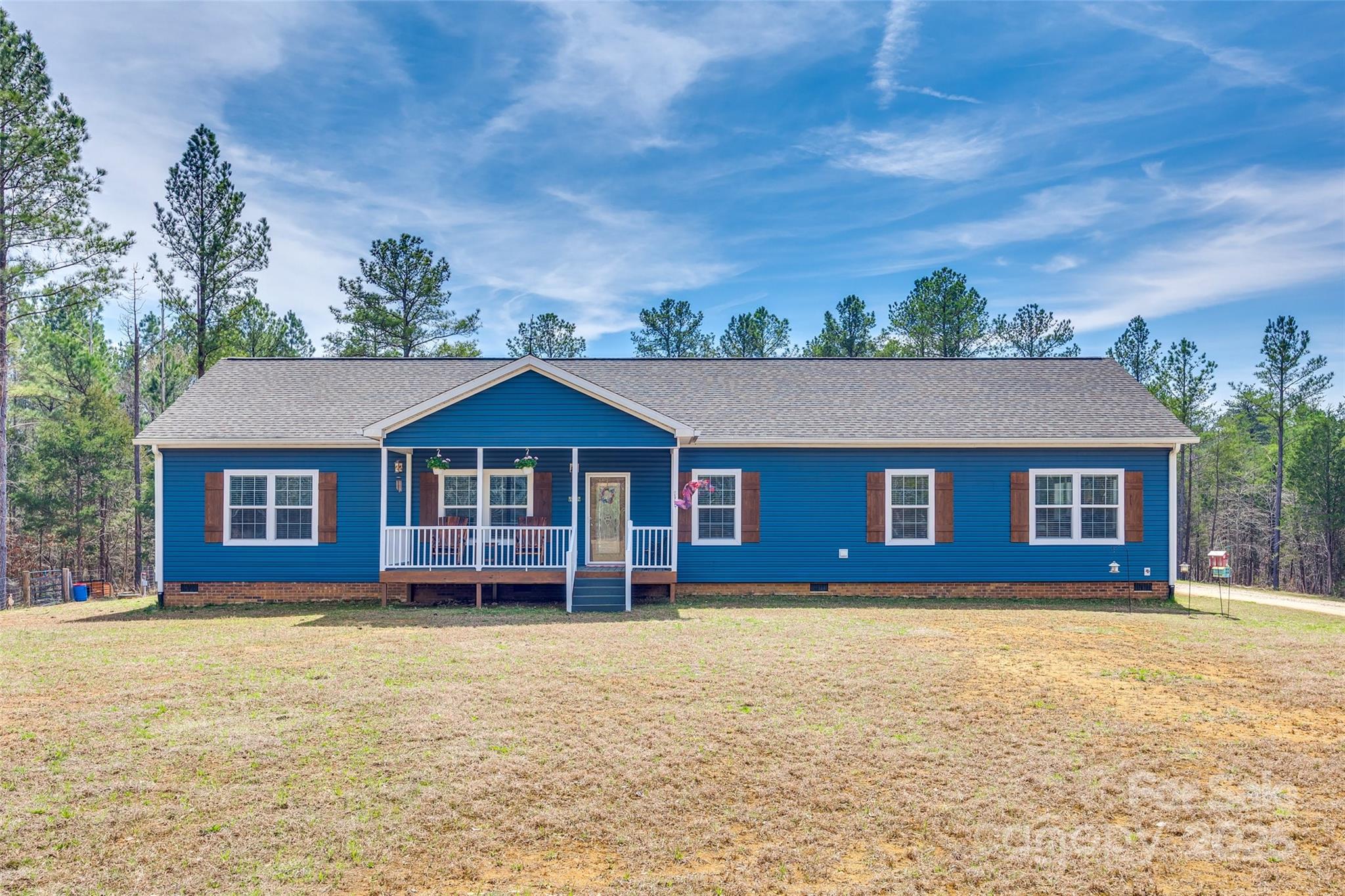 Spacious 4BR/2BA Home - Private & Peaceful! Escape to your own private retreat with this great home nestled on over 60 acres of beautifully wooded land. Designed for both comfort & functionality, this home features a split bedroom floor plan, an oversized family room with a cozy wood-burning fireplace, & durable vinyl plank flooring throughout the main living areas. The primary bedroom is spacious & features an en-suite bath & a large walk-in closet. Enjoy outdoor living with a covered front porch & a screened rear, offering the perfect space to relax & take in the natural surroundings. A separate laundry room adds convenience, while the expansive property provides endless possibilities for outdoor enthusiasts. This incredible property also features a 30x40 metal shop, a fenced dog lot, & over 3,000 feet of road frontage, making it a truly unique opportunity for those seeking space, privacy, & versatility. This is a rare opportunity to own a spacious home on a large, private estate.