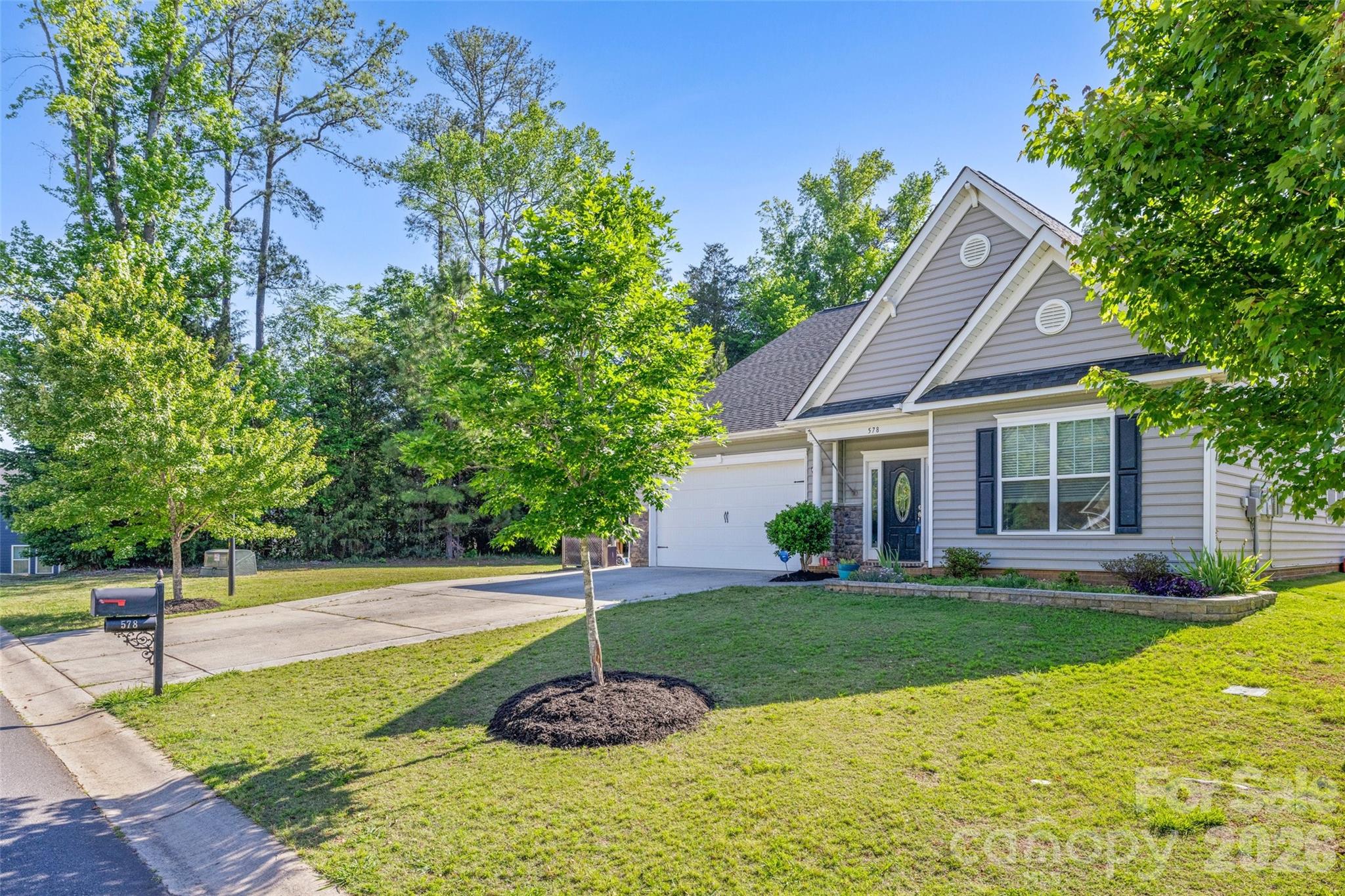Imagine coming home to one of the more private lots in Tullamore, where there is no neighbor on the left and the backyard is a peaceful retreat filled with blooming gardens and mature fruit trees. Whether you're picking peaches in the summer, tending the raised garden beds, or relaxing outdoors after a long day, this home offers space to slow down and enjoy everyday moments.

Inside, the flexible five-bedroom floor plan—with three bedrooms on the main level and two upstairs—adapts to every stage of life. It's ideal for multi-generational living, welcoming overnight guests, creating dedicated home offices, or simply giving everyone room to spread out. An oversized driveway accommodates up to five vehicles, while the large storage shed provides plenty of space for hobbies, outdoor equipment, or even a golf cart.

Located in one of Clover's most sought-after communities and zoned for the new high school, this home combines privacy with convenience. Just a short walk away, Field Day Park offers pickleball, walking trails, athletic fields, and open green space—making it easy to stay active or enjoy time with family and friends. Everyday essentials, including grocery stores, restaurants, banks, and shopping, are only minutes away, giving you the perfect balance of peaceful neighborhood living and modern convenience.

To top it off, the home features a brand-new tankless water heater (2026), providing added efficiency and peace of mind for years to come.