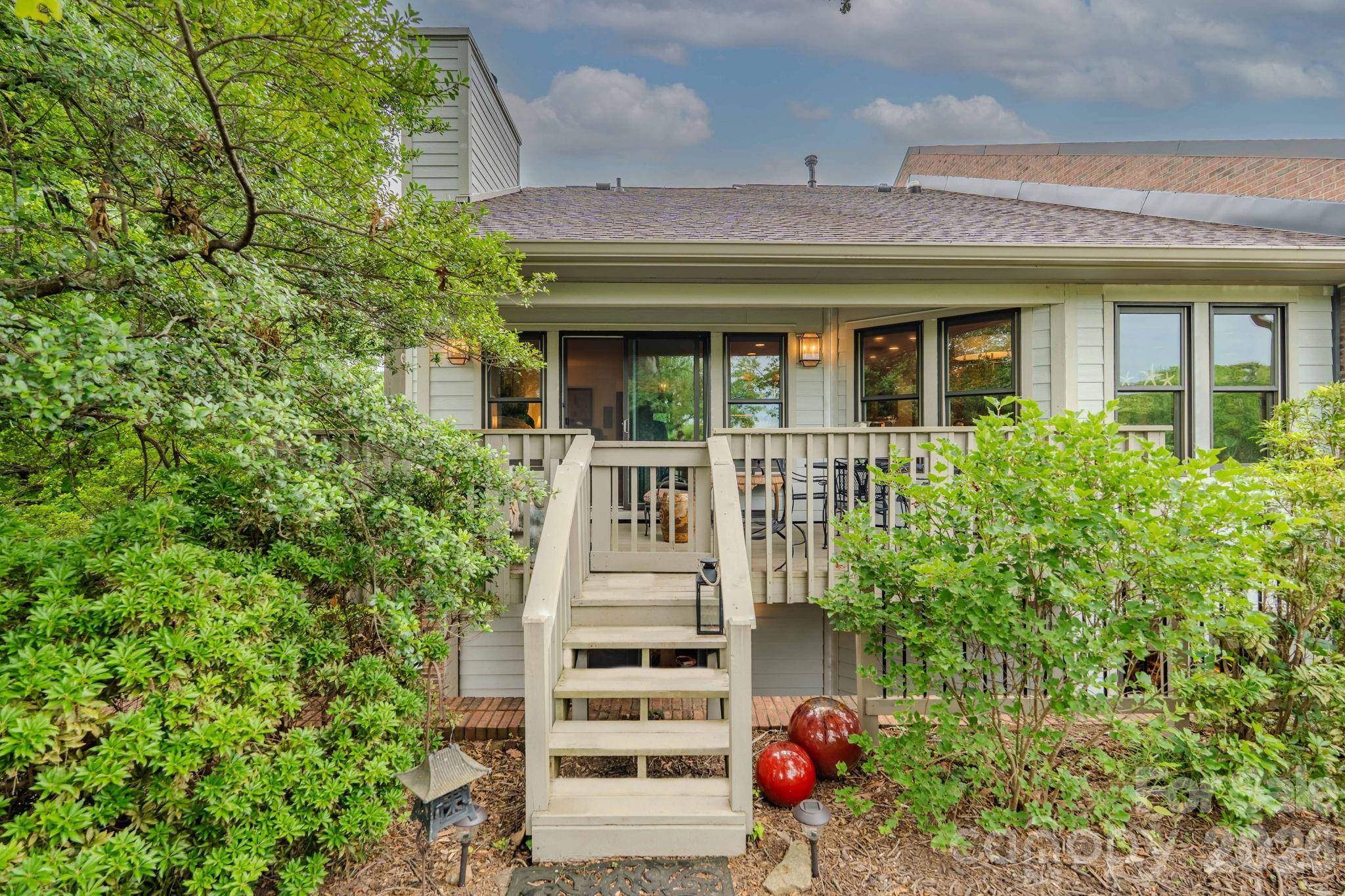 Bright and beautiful, nestled in charming Tryon – known as “The Friendliest Town in the South” -  this updated end-unit condominium in sought-after Oak Hall is ideally located just a short stroll to downtown shops, restaurants, the library and Tryon Fine Arts center. Perfect for those seeking primarily one-level living, the main floor offers a spacious open floorplan featuring living room with a gas-vented fireplace, kitchen, dining area, as well as a primary ensuite bedroom + guest bedroom with additional full bathroom. 

The fully finished daylight lower walk-out level offers outstanding flexibility with a separate entrance and its own private patio area. It features den/recreation room, third bedroom, full bath, and second kitchenette—creating an ideal guest suite, in-law or caretaker quarters, home office, or private retreat for extended stays. Additionally, on the lower level, is a huge, 29’ x 27’ unfinished basement area, currently utilized as an art studio with work bench.  This space has tons of storage capability and so many possibilities.  How many condos can you find with actual work/hobby space and storage capacity? 

This special residence is privately positioned overlooking an expansive common-area greenspace with mature trees and cozy firepit. The end unit enjoys exceptional privacy, abundant natural light from an extra wall of windows and distant mountain views. 

Recent improvements provide peace of mind and include a new HVAC system, tankless water heater, lighting fixtures, exterior hardboard siding, roof, gutters, and fresh paint.

All assessments for recent exterior improvements and updates by the condo association have been paid in full by Seller.

Whether you are seeking a full-time home, lock-and-leave retreat, or a welcoming place to spend with friends and family, Unit 106 presents an outstanding opportunity to enjoy one of Tryon’s most desirable lifestyles.  Come experience the warmth, convenience and serenity that make this exceptional Oak Hall condominium truly feel like home.