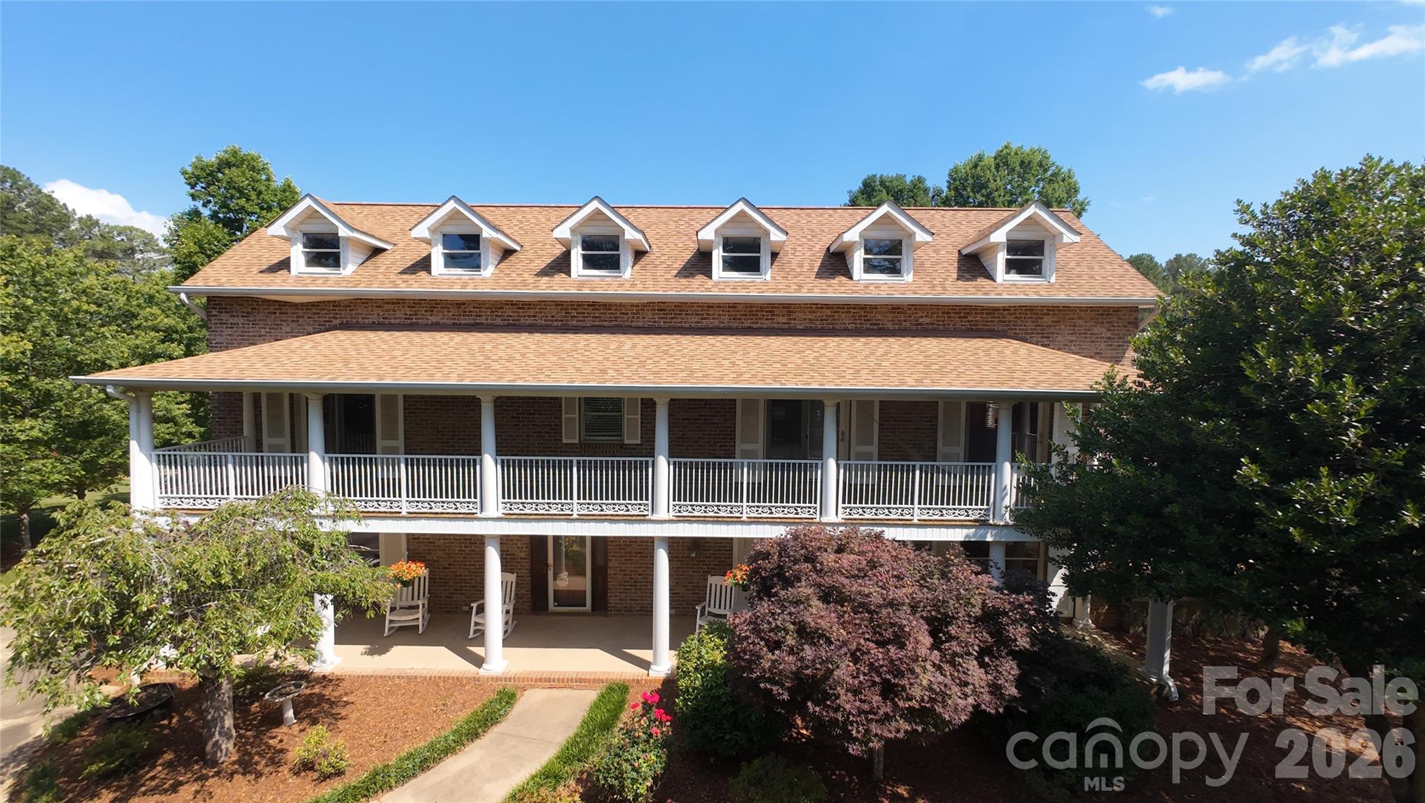 This incredible 2.5-story brick estate sits on over five acres, offering a tranquil country atmosphere just minutes from Uptown Shelby's shopping and dining. Beautiful mature landscaping, includes Japanese maples, weeping cherry trees, muscadine grapes and roses, alongside expansive pastures. The 27 * 40 foot barn is perfect for the hobbyist or serious farmer, equipped with its own internet connection, heating/cooling, and a loft area. A large tractor shed provides ideal storage for machinery. The home boasts amazing curb appeal, featuring large ornate balconies and third-floor dormer windows that ensure amazing views and abundant natural light.  Enter the grand foyer where the main staircase spirals to the second floor. The main level is accented by cherry hardwood floors and dental molding in the dining room, and a spacious, inviting den. The kitchen is designed with true chef-quality potential, featuring a large cedar-lined pantry, a Viking range for cooking large meals, and a generous granite island with numerous sinks. The brick surround, red tile flooring, and skylights create a warm and inviting atmosphere. A two-sided fireplace heats both the dining area and the living room, which overlooks the pool deck. The main level is completed by a spacious bedroom and a laundry room with a large sink.  The second floor offers three large bedrooms, including a luxurious primary suite with an ensuite bathroom featuring a separate rainfall shower, a modern soaking tub, and granite countertops. The remaining bedrooms share a full bath. A laundry chute adds convenience, and the large balconies are perfect for enjoying warm summer months. The large bonus room is perfect for movie nights or game time.  The versatile third floor includes added soundproofing and its own bathroom, making it ideal for visitors. The backyard features a large in-ground pool, a built-in pergola, raised vegetable garden beds, and mature muscadine vines. The backyard features a large optional sun shade that can provide additional cooling during warm summer months and can be removed to ensure more sun in the winter months.  A large attached workshop is perfect for work or play.  For the true car enthusiast, the large three-bay garage features a unique built-in car wash station. Located just over a mile from the nearest hospital and only two miles to Uptown Shelby, this home's unique features and acreage are truly exceptional. An additional 5.48 acres are available for sale under MLS #4384371. Schedule your private showing today!