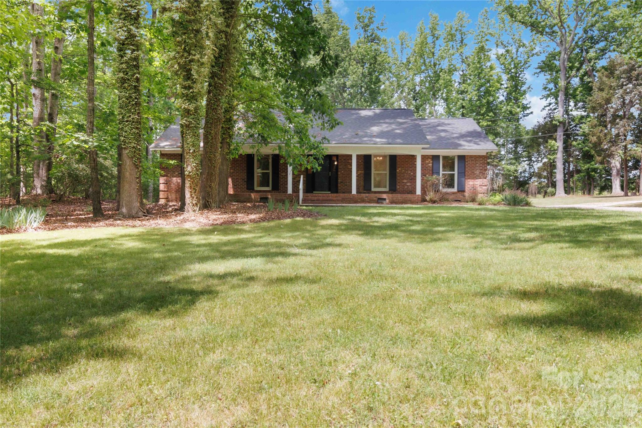 A Secluded Haven:  Brick Ranch on Nearly 3 Acres.  Escape to your own private sanctuary!  This 3 bedroom, 2 bath brick ranch is perfectly positioned on 2.706 acres, offering a rare level of privacy and space.  Inside, the sizable great room with its wood-burning fireplace creates an inviting atmosphere for relaxation.   Enjoy the peace of mind that comes with a 2024 roof replacement and the added versatility of a large unfished basement perfect for a home gym, workshop or additional storage.  Whether you're looking for room to roam outdoors or a solid, low maintenance exterior, this property delivers.  Nestled away from the hustle and bustle!