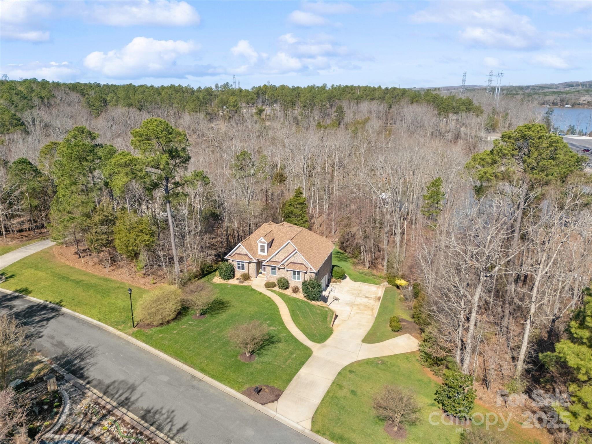 Resting on the beautiful shores of Lake Wylie, South Carolina and what can only be described as an entertainers dream... we find 145 Mariners Bluff Road! A custom all brick open floorplan home with 2889sqft of living space. 1.57acres. Large primary bedroom suite on the main with 3 walk-in closets, stunning bath, dual vanity sink, large shower, and jetted tub. Two story great room with natural light that leads right to the chef's kitchen with gas 6 burner Thermador cooktop! Screened patio & open deck with new synthetic decking! Well appointed & fully completed walkout basement with rec room & wonderful wet bar! Two bedrooms & one full bath! Large two car garage & plenty of storage area! Covered & open stone paver patio with private outdoor shower! An additional stone patio with built in firepit! A spectacular dock updated 2024 with covered slip/boatlift, upper sundeck & floating platform that is sure to please. Gazebo overlooking lake! Low SC taxes and Clover award winning schools!