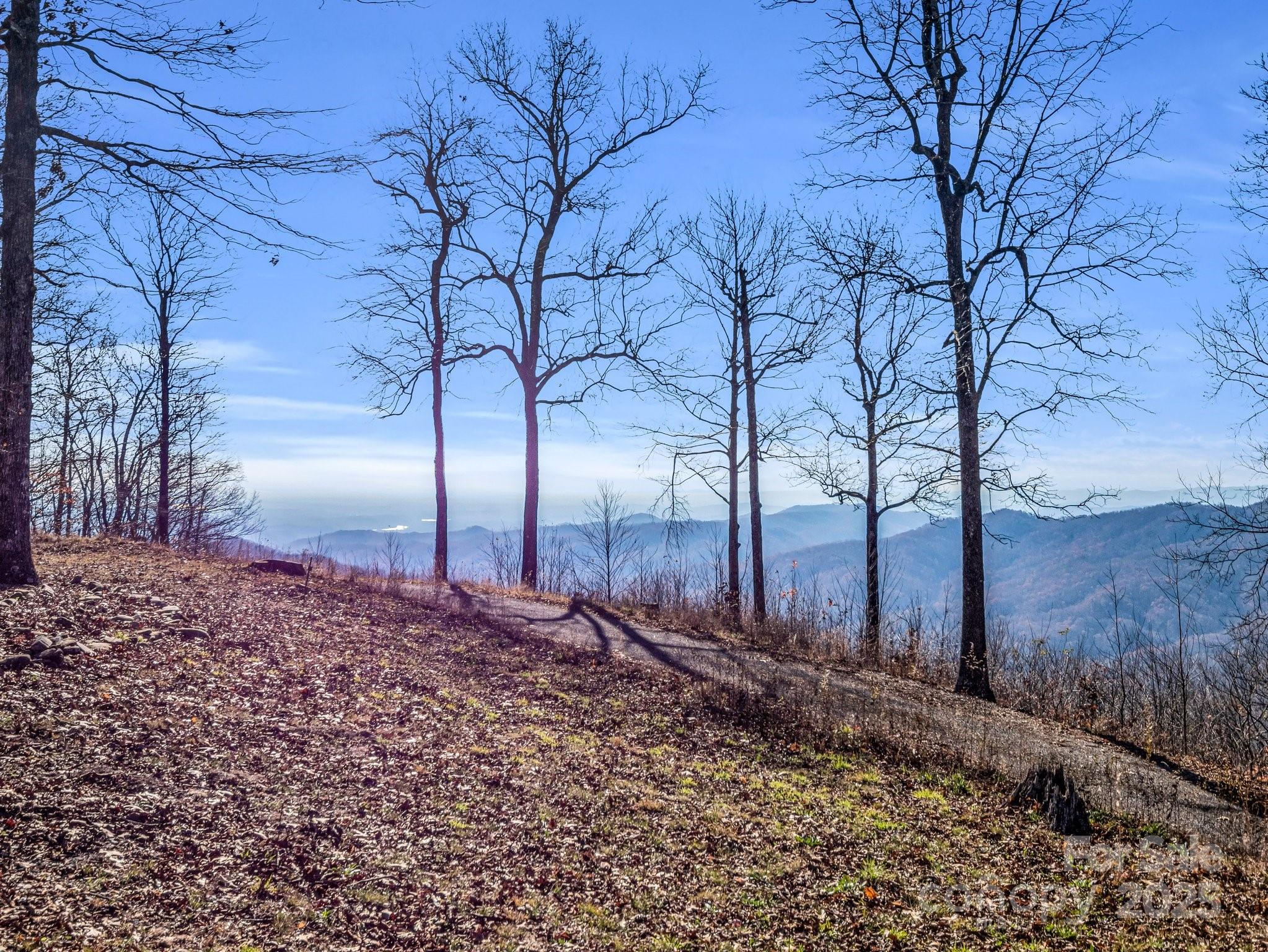 If you are looking to build a dream retreat, this 22-acre mountaintop property provides the ultimate opportunity. Believed to be the highest residential point in South Carolina at an elevation of 3,320 feet, you’ll enjoy 180-degree views of the Blue Ridge Mountains to the west, and Lake Jocassee and Lake Keowee to the south. With selective cutting on the east side, you could have a sunrise view and a view of Sassafras Mountain. The north side of the property is about 200 yards from the North Carolina state line. With two deep wells supplying crystal-clear water, underground utilities in a gated community, and a renovated chestnut and stone log cabin for temporary living, this property is the perfect canvas for your future haven. Appreciate the serenity of nature while still being close to Brevard, North Carolina, and several cities in upstate South Carolina- the perfect balance between seclusion and convenience. Don’t miss your chance to turn this rare gem into the home of your dreams!