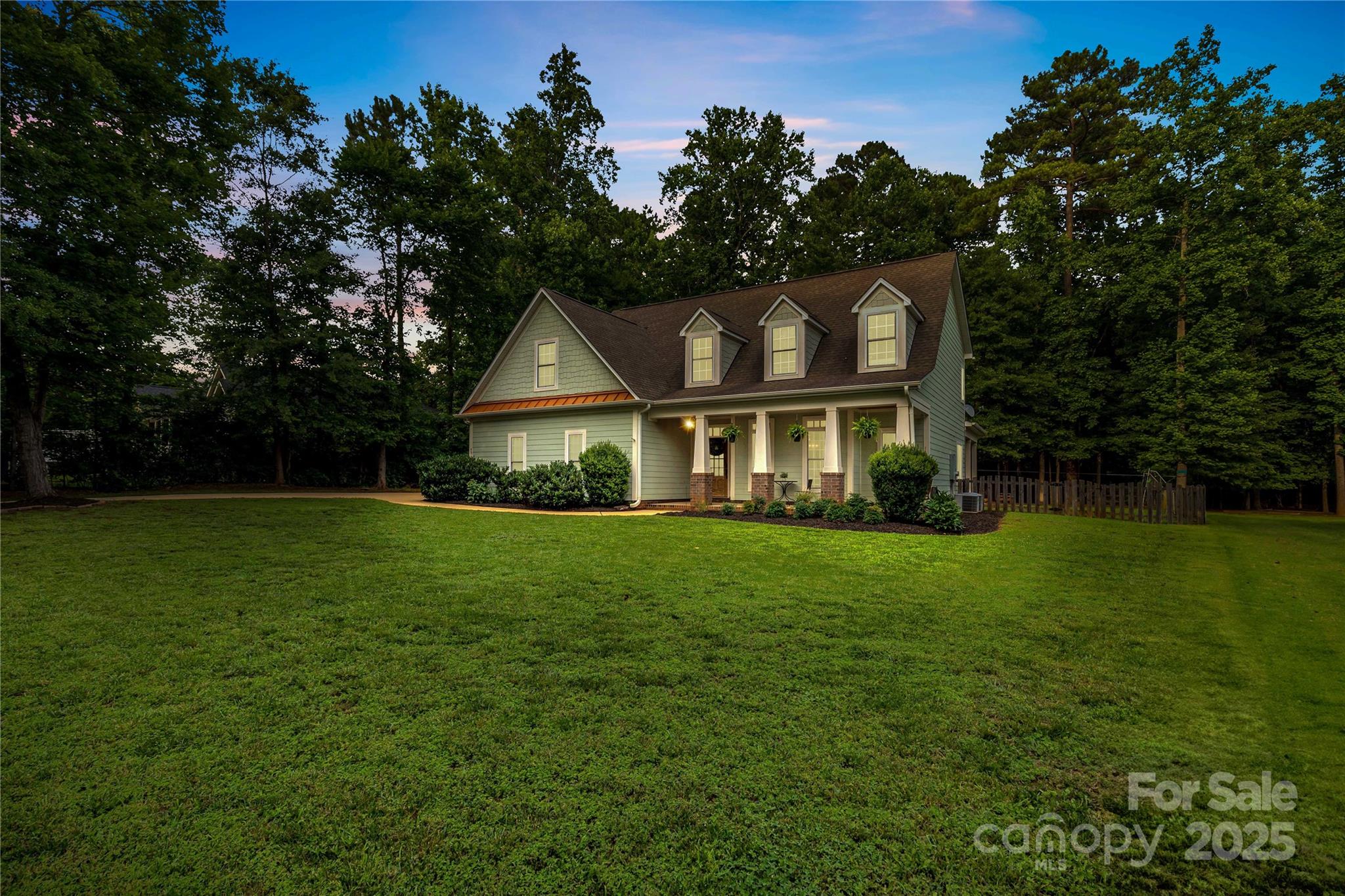 Welcome home to 481 Evergreen Rd, a stunning custom-built home situated on over an acre in the desirable Lake Wylie area. This beautiful home features an open floorplan with high-end finishes throughout, including gleaming prefinished hardwoods, granite countertops, stainless steel appliances, a large kitchen island, and a cozy breakfast nook perfect for morning coffee. The main level offers a convenient bedroom and full bath—perfect for guests or a home office. Upstairs, you’ll find the spacious primary suite with an ensuite, along with three additional bedrooms and a full bath. A mini split AC/heating unit has been added in the garage, providing year-round comfort for hobbies or additional workspace. Step outside to enjoy the rear covered patio overlooking a generous fenced-in backyard, surrounded by mature trees that provide peaceful privacy. Ideally located close to Lake Wylie’s shopping, dining, & amenities, this home offers the perfect balance of comfort, style, & convenience.
