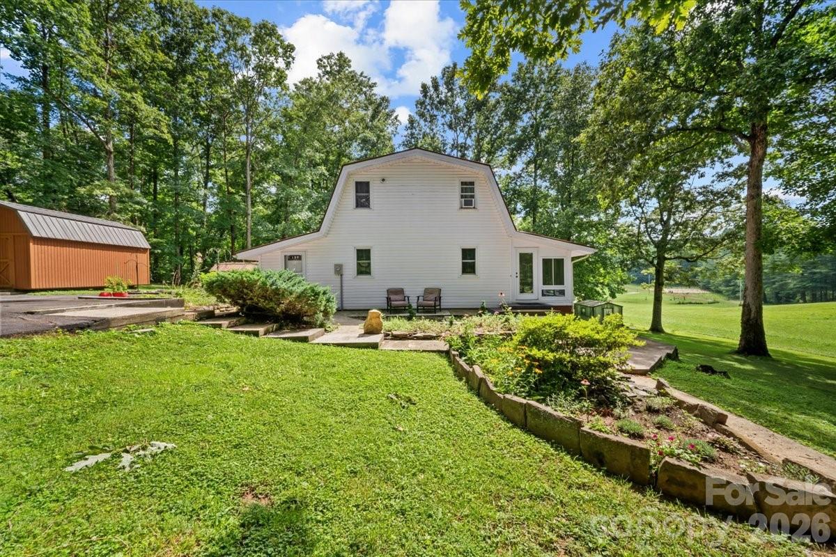 Welcome to your own slice of country paradise! Nestled on approximately 2.5 picturesque acres, this charming farmhouse invites you to slow down and enjoy the simple things—morning strolls down quiet country roads, evenings in the sunroom, and views of rolling fields in every direction. Inside, you'll be welcomed by soaring 20-foot, beautiful wood beam ceilings, rich hardwood floors, and a cozy wood-burning stove that creates the perfect gathering place on cool evenings. The inviting living room flows into a thoughtfully designed dinning and kitchen featuring granite countertops, while the functional mudroom with laundry adds everyday convenience. The sunroom offers a peaceful place to relax and take in the surrounding countryside.The main level features a bedroom, a full bathroom, and an additional bedroom  or would make an ideal home office, guest room, or hobby space. Upstairs, you'll find another bedroom, a half bath, and a generous cedar walk-in closet. The home offers 1,303 heated square feet, plus an additional 506 square feet of finished space that is not included in the heated square footage due to the absence of direct heating vents. The current heating system has kept the space warm and comfortable for the current owners needs. Outside, you'll discover meticulously maintained grounds filled with mature landscaping, including a beautiful magnolia tree and a variety of established trees and flowering plants. A greenhouse and two additional storage buildings provide endless opportunities for gardening, hobbies, or extra storage. Lovingly cared for over the years, this special property offers more than just a home—it's a lifestyle where peaceful mornings, beautiful views, and timeless farmhouse charm await. Be sure to ask your real estate agent for the additional property information and attachments provided by the sellers. They've taken the time to compile valuable details about the home, property, and its features to help buyers better understand all this special property has to offer.