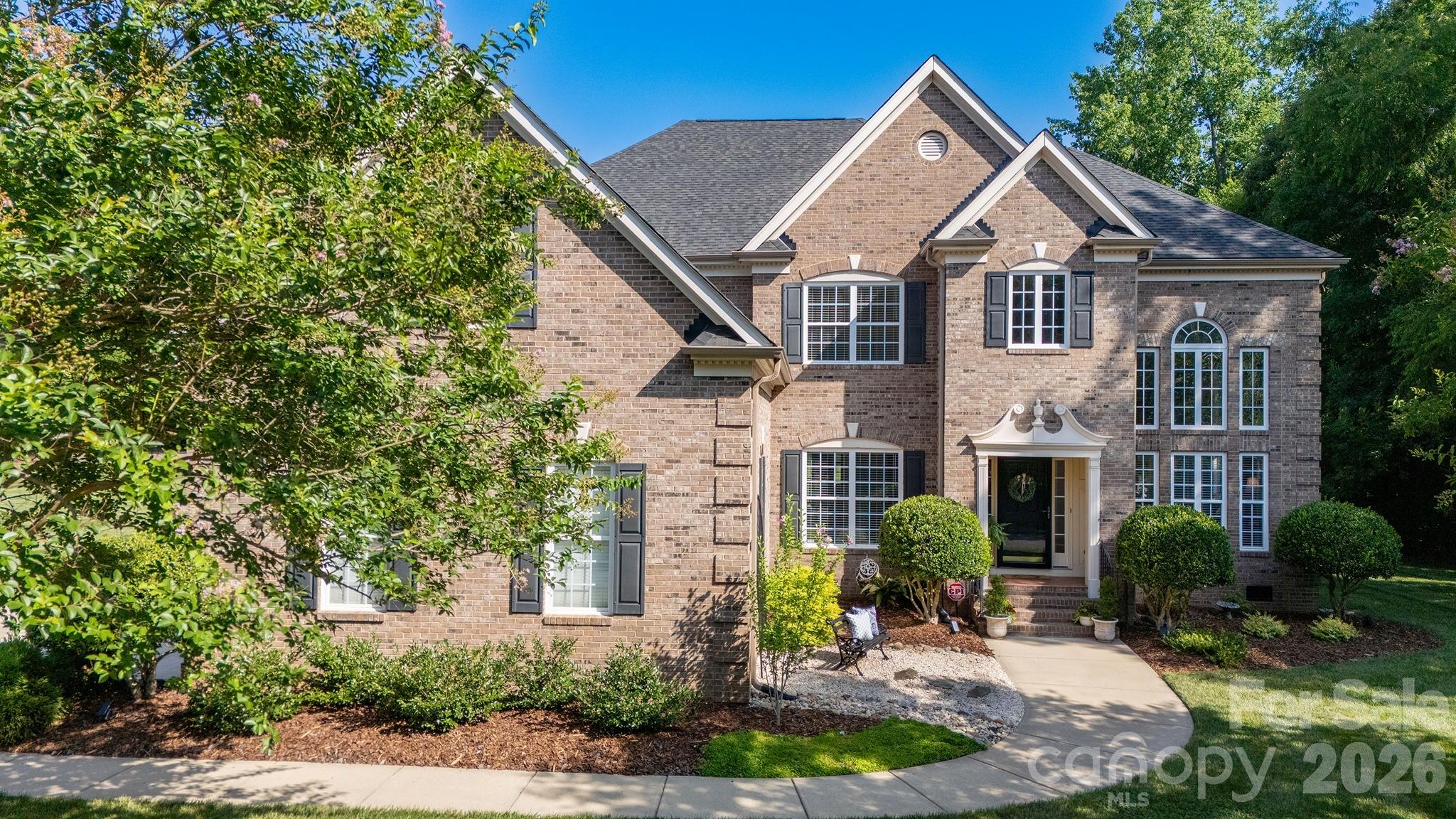 Exquisite full brick, 6 bedroom, 5.5 bath, 3 car garage, executive home nestled on a .91 acre lot located in the highly sought after Blackstone community in Matthews. Premium perimeter lot in the community backing up to wooded HOA common area offering a "no neighbor view" directly behind property (property line goes well into wooded area - see attached survey). Superior mechanical condition boasting a new 2025 Architectural roof, 2025 gutter system, 2025 hot water heater, 2024 main water pressure reducing valve, 2024 exterior storm doors, 2023 CPI security system, 2021 sealed crawlspace with dehumidifier and condensate pump, and 2017 replaced HVACs. Stunning curb appeal from the street with lush green lawn, in ground irrigation system, mature landscaping, stone gravel accents, ornamental plants, fresh bark mulch, and well-maintained flower beds. The inviting covered front porch leads to a dramatic two-story foyer entrance and grand exposed staircase with 2021 carpet runner. This floor plan offers a perfect combination of pure elegance with sought-after modern-day functionality and flexibility. Spectacular two-story great room offers a versatile space for your personal needs - currently used as an oversized dining room to host large gatherings and accented by wall of windows, gorgeous 2021 refinished hardwood floors, neutral fresh interior paint, two inch blinds, and intricate crown molding. The sunroom doubles as an executive home office with wall of floor to ceiling windows and French Doors leading to a private secondary deck overlooking the backyard. The popular circular traditional layout continues extending to an open living room and kitchen combination perfect for entertaining and hosting holidays or game days! The living room is accented by decorative columns, recessed lighting, gas log fireplace, custom built in cabinetry, 2021 carpet, surround sound, abundant natural light, and direct access to the relaxing rear deck. The spacious eat in kitchen is a cook's delight featuring 2026 painted cabinetry, granite countertops, stainless steel appliances including desirable gas cooktop, center kitchen island with breakfast bar, updated cabinet hardware, upgraded hardwood floors, sunlit bay windowed breakfast nook, walk-in pantry, and separate Butler's pantry providing ultimate storage. The main level living space continues with another formal living room/dining room (your choice to fit personal needs), private guest bedroom with remodeled attached full bathroom, walk-in laundry room, convenient half bath, and direct access to the oversized three car garage. Dual staircases lead to the second level where you will find a delightful primary bedroom with sitting room, three additional auxiliary bedrooms, three full bathrooms, and large two-tiered rec/bonus room. The primary bedroom retreat offers two separate walk in closets, sperate sink vanities, 2026 glass shower enclosure, large jetted garden tub, and private water closet. The back staircase leads to the third and fourth bedroom with a full bathroom on the second level that has a door to close off as a private guest quarters. The three full bathrooms on the second level offer 2025 plumbing fixtures, lighting, and mirrors. On the third level you will find another private bedroom with attached full bathroom - lots of possibilities for multigenerational use with this floor plan. Highly coveted attached three car garage with expanded driveway for multiple car parking. Main garage door motor, spring, and system replaced in 2021 and garage shelving added in 2022. Blackstone offers residents well manicured common areas, community outdoor pool, poolhouse, playground, lighted tennis court, and walking trails for residents to enjoy. Prime Matthews location - short walk or drive to grocery stores, retail shopping, restaurants, banks, services, and more!