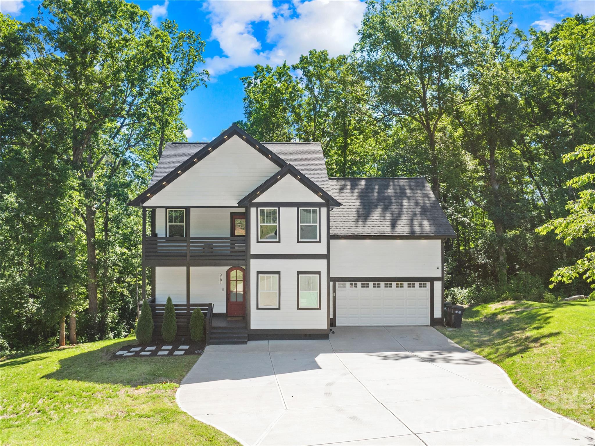Step into modern luxury with this like new, meticulously maintained custom style home nestled on a private wooded lot with NO HOA. Far from your typical cookie cutter construction, this stunning residence blends sophisticated design, upscale finishes, and exceptional indoor outdoor living to create a truly elevated experience.

Offering nearly 2,600 square feet with soaring 10 foot ceilings on the main level, this home showcases trey ceilings throughout multiple rooms, designer lighting, gorgeous flooring, and an abundance of natural light. The striking modern farmhouse inspired exterior paired with bold architectural accents immediately sets this home apart.

The chef inspired kitchen features crisp white cabinetry, stunning countertops, designer backsplash, stainless steel appliances, breakfast bar seating, and a spacious breakfast nook, all flowing seamlessly into the main living spaces ideal for entertaining or everyday luxury living. Flexible spaces including a formal dining room or home office provide versatility for today’s lifestyle.

Retreat to the spacious owner’s suite featuring elegant trey ceilings and a spa inspired ensuite complete with a freestanding soaking tub, separate shower, dual vanities, and illuminated touch light mirrors. Additional generously sized bedrooms and baths provide comfort and functionality for family and guests alike.

Designed with entertaining in mind, the upper level bonus room with built in bar creates the perfect media, lounge, or game room experience. Outside is where this home truly shines. Enjoy your own private outdoor retreat featuring an expansive double level deck, jacuzzi spa, mounted outdoor TV, and wooded views creating the ultimate atmosphere for relaxing evenings, hosting guests, or game day gatherings year round.

This distinctive modern luxury home in Charlotte is one of a kind and it can be yours today. Welcome Home!
