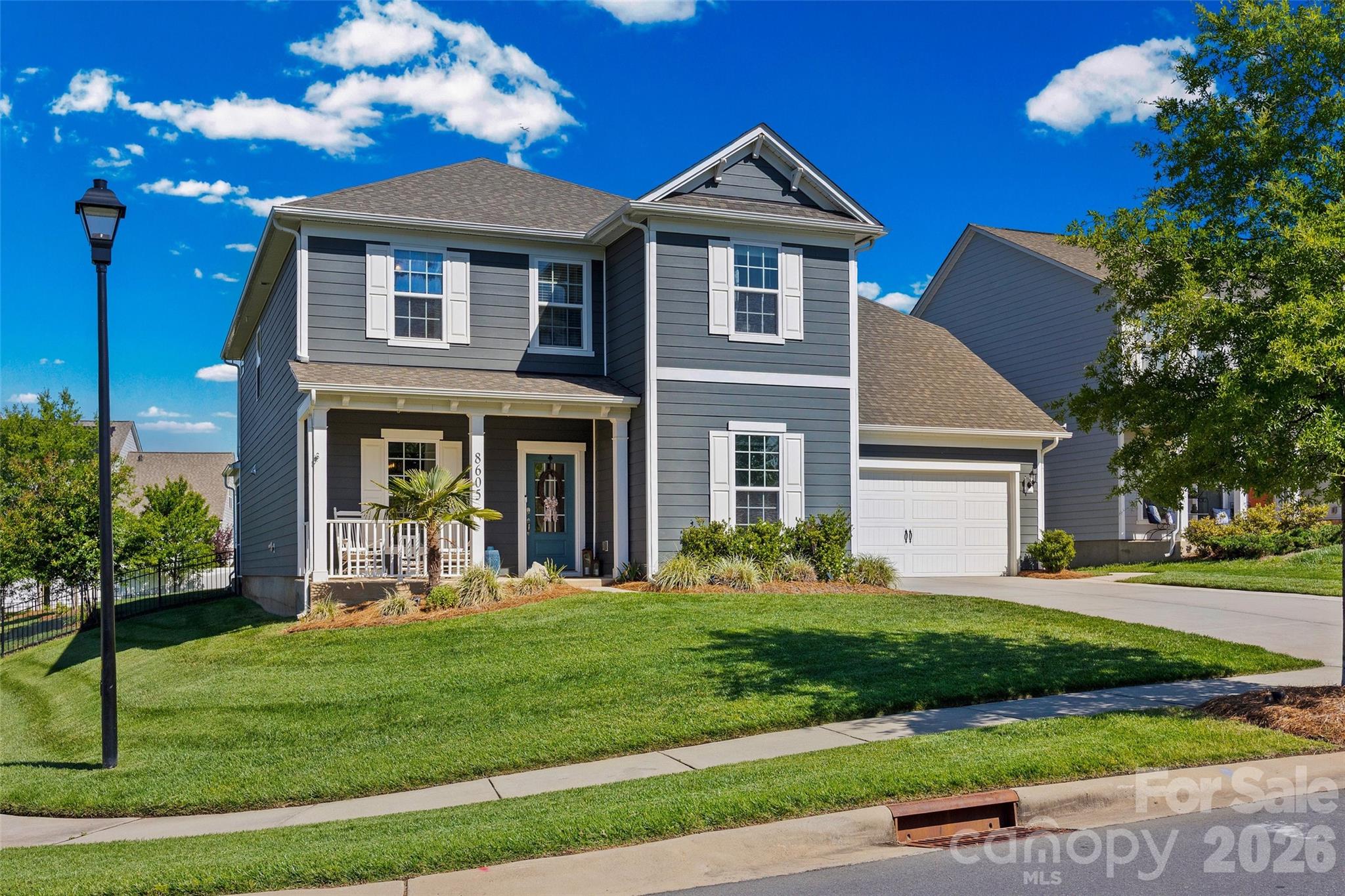 Absolutely stunning two-story home on a large corner lot in the desired McCullough Community! The main level showcases beautiful LVP flooring throughout, a private office with a glass door, and a formal dining room with a butler's pantry.  The gourmet kitchen is designed for entertaining with a large island, granite countertops, stylish backsplash, gas cooktop with exhaust hood, wall oven and an oversized walk-in pantry. The open-concept family room features a stone fireplace and large windows, while the adjacent flex space includes a built-in granite desk/drop zone and additional storage. Upstairs features the luxurious primary suite with separate vanities, a walk-in shower, soaking tub, private water closet, and linen closet. You will also find 3 secondary bedrooms with walk-in closets, a hall bath with dual sinks, and a laundry room with ample storage.  A large bonus room with oversized walk-in attic access provides incredible flexibility and storage. Enjoy outdoor living year-round with a back porch with retractable screening, an expansive patio, a fenced-in level backyard, a swing set, and covered front porch. The exterior also features custom programmable color changing trim lighting to celebrate every season. Car enthusiasts and hobbyists will love the rare 4-car garage offering ample storage, mirrors, a mini-split unit for heating/cooling and built-in speakers. This exceptional home combines luxury, functionality, and entertaining space in a highly desirable corner-lot setting with common space across the street. Enjoy resort-style community amenities including an elegant clubhouse, 2 pools, tennis courts, dog park, pickleball courts, walking trails, a fitness center and more. Conveniently located near shopping, dining, downtown Pineville and Fort Mill, Easy Access to I-77 and 15 minutes to uptown Charlotte.  Make this Beautiful Home YOURS!