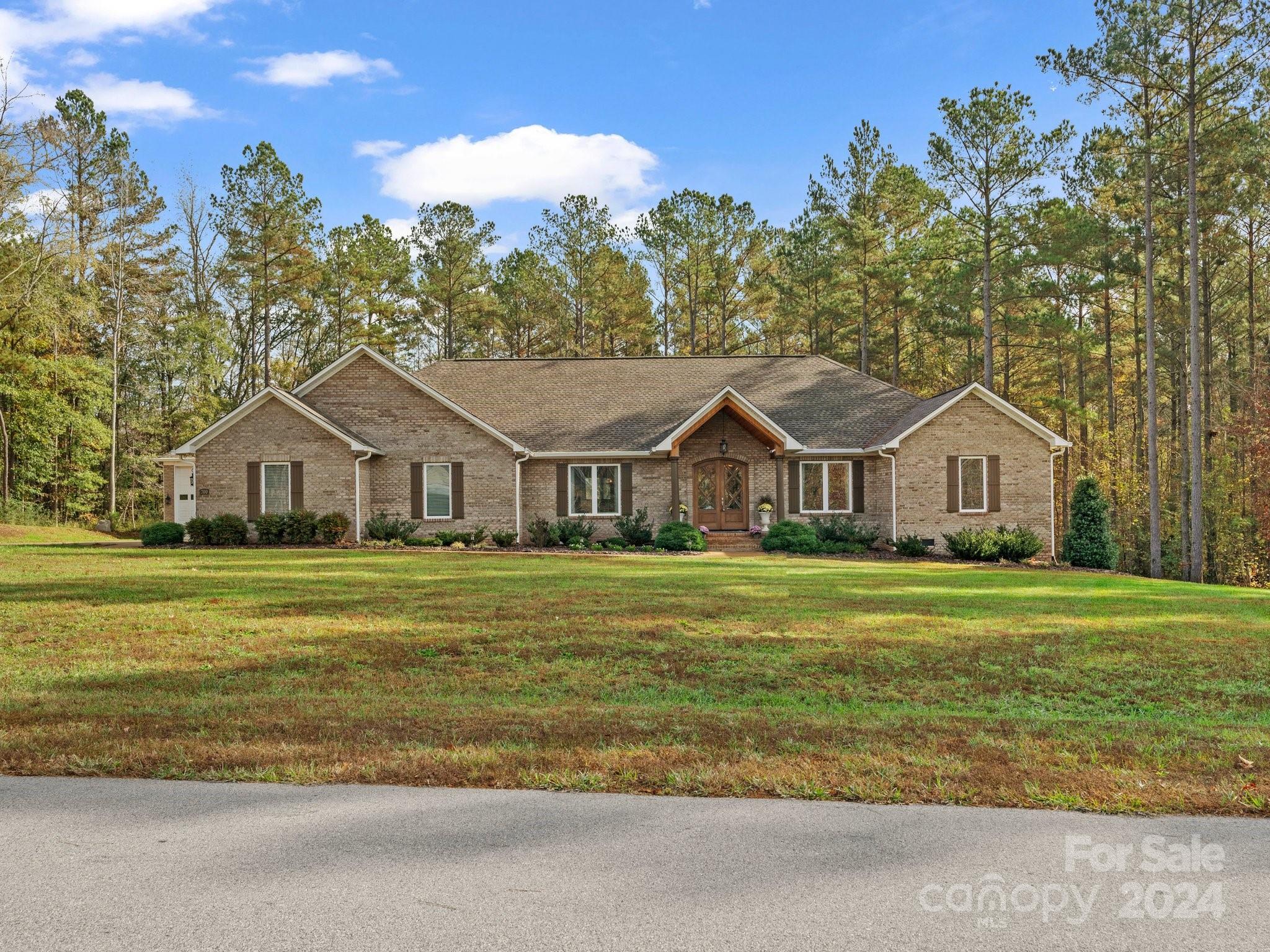 Private Luxury Living on 3.5 Acres
Experience  privacy on this beautifully wooded 3.5-acre lot. This custom-built 3-bedroom, 3.5-bathroom home combines thoughtful design with modern elegance. The spacious kitchen features Quartz countertops,  large island,with a chef’s kitchen equipped with a six-burner gas stove, microwave drawer, and a full refrigerator and freezer. Home has open concept that flows seamlessly into the living room, highlighted by a stunning stone-faced gas-log fireplace. The primary bedroom is a true retreat, featuring tray ceilings and a huge walk-in closet. Enjoy hosting in the large dining room and spacious office area with two closets that could easily be converted into a fourth bedroom.Step through the sliding doors onto a 16 x 30 gable-roof patio, offering a perfect transition to your outdoor oasis. The centerpiece is a 20 x 40-foot pool with a diving board and slide, creating a backyard paradise.
 30 x 48-foot RV garage all brick exterior. And Clover Schools.