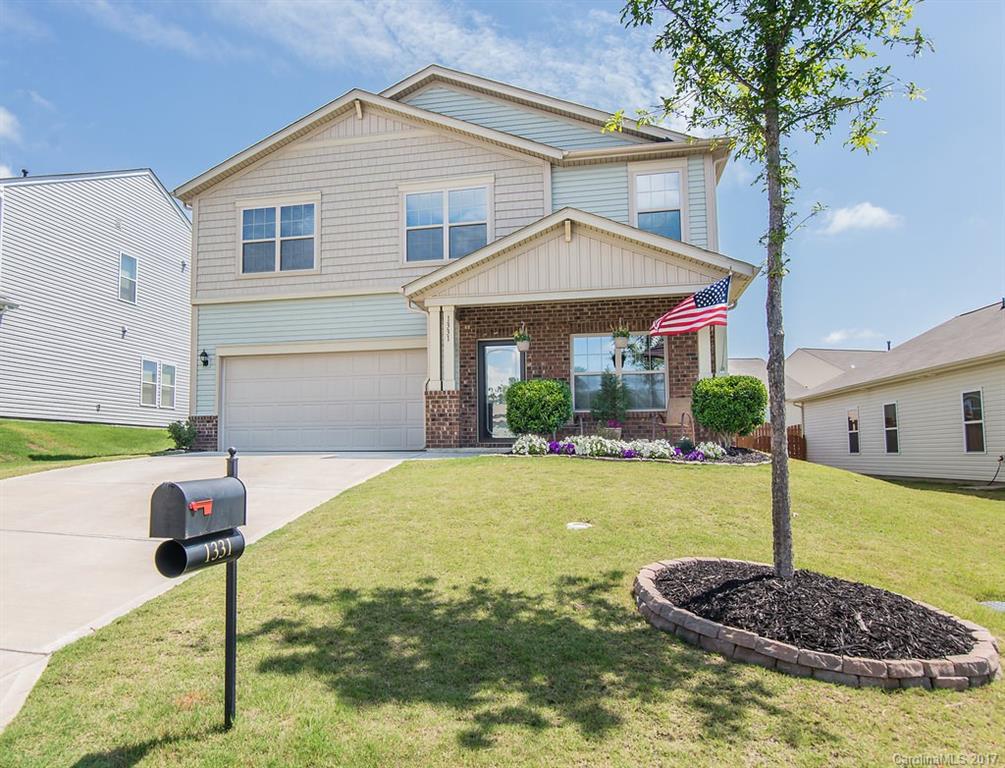 Covered front porch, Open floorplan with wide plank hardwood floors, granite counters, gourmet cabinets, pendant lighting, custom travertine backsplash, office nook, gas logs/great room, loft area, study/office/or 5th bedroom,  flat backyard/extended patio/fenced.