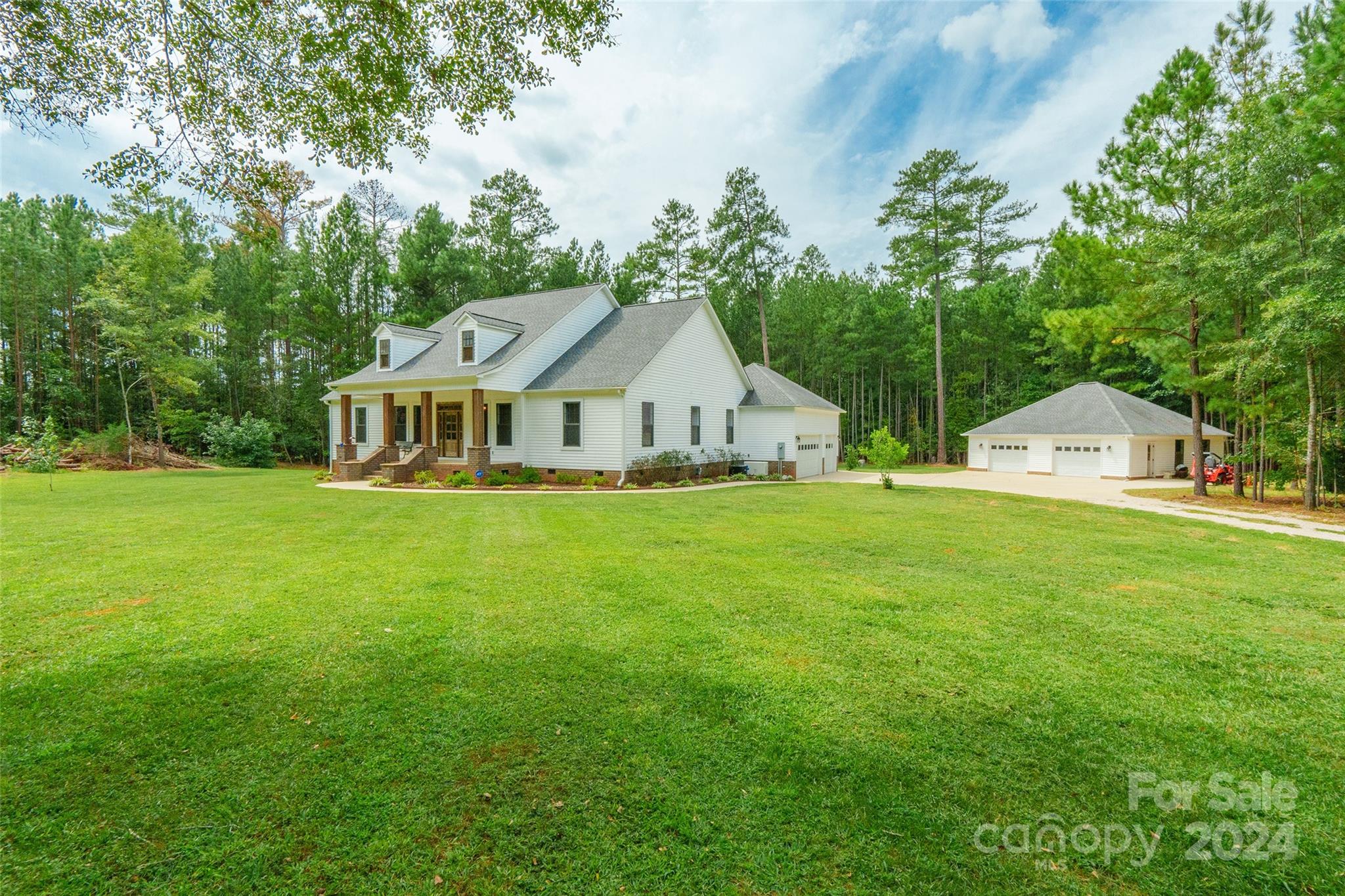 Welcome to this stunning residence, set on 6.5 acres in the Derby Downs equestrian community. A charming covered front porch invites you into this elegant 3 BD, 2.5 BA home, featuring an additional room ideal for an office. The open floor plan boasts engineered hardwood floors throughout the main living areas. The kitchen, equipped with a pantry & breakfast bar, seamlessly connects to the living room, which features a fireplace, vaulted ceilings, & views of the back yard. The primary suite is a retreat with tray ceilings & direct access to the covered back porch. The ensuite bathroom includes a separate shower, garden tub & walk-in closet. For those seeking more space, the attic can be accessible via a planned staircase from outside the laundry rm, offering potential for a bonus rm. Car enthusiasts will appreciate the 3-car attached garage & a 2-car detached garage, vaulted and ready for a car lift. And, with the septic system in the front, there’s room for a pool addition in the back!