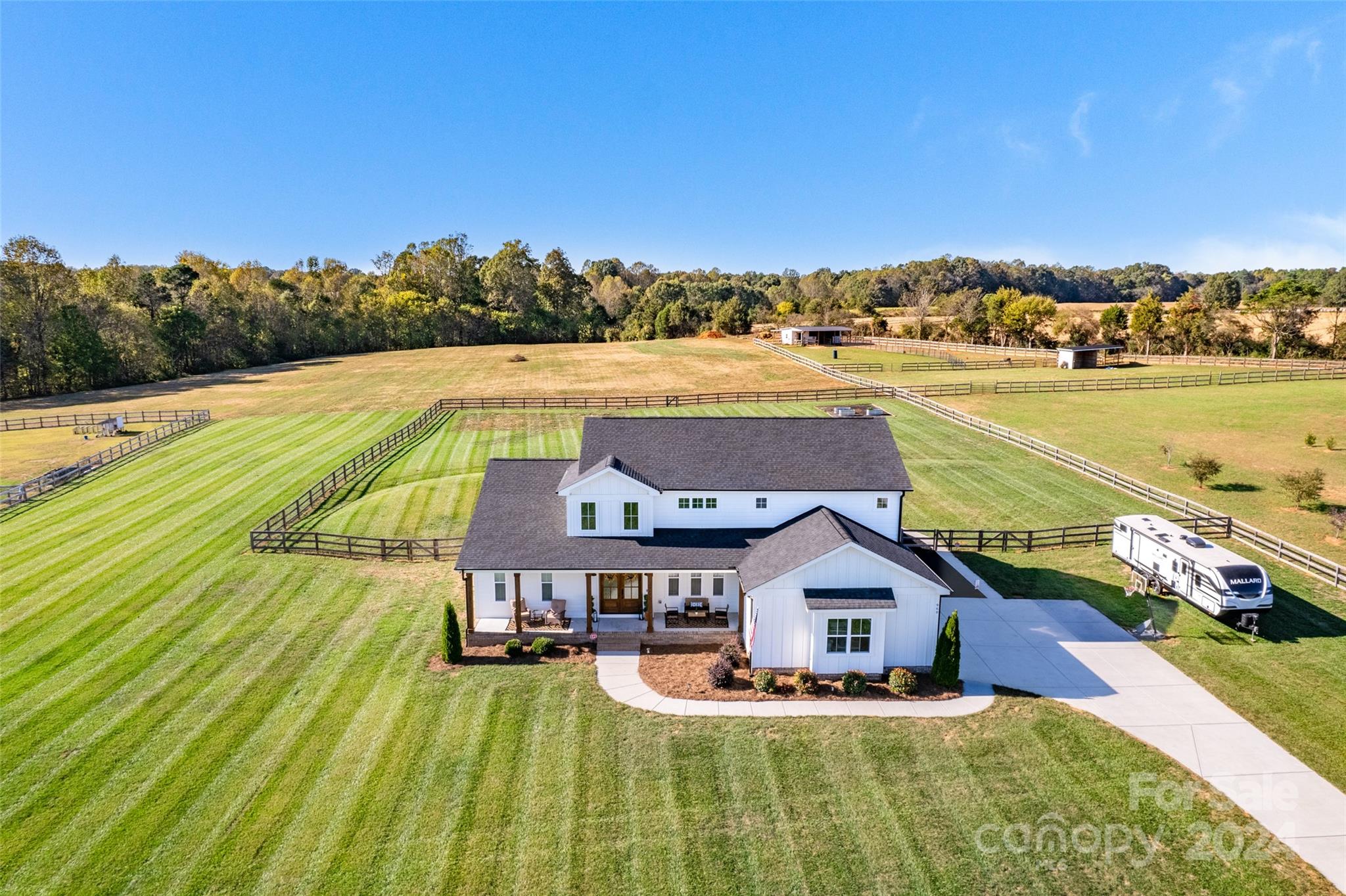 This like new, custom designed home sits on a HARD TO FIND 5.55 acres, just minutes from Mooresville! As you come up the long driveway, you'll see the well maintained front yard and oversized covered front porch with cedar columns, lots of seating and ceiling fans...just asking you to come relax. Come into your 2-story foyer & open floor plan. Living room includes beautiful built-ins to hold your books & a floor to ceiling stone fireplace. Kitchen includes an oversized quartz island & barn door pantry. A huge custom primary suite with a large shower & tub. On the opposite side, you'll find a guest room, full custom bath & office (or flex space)! Up the hardwood stairs you'll find a bonus area, 2 bedrooms & 2 bathrooms (one ensuite!) The back patio overlooks acres of open area-perfect for watching sunsets, raising animals, gardening or recreation. This property is the best of country living with city conveniences nearby! So much to list, this rare gem is a must see! Agent is owner.