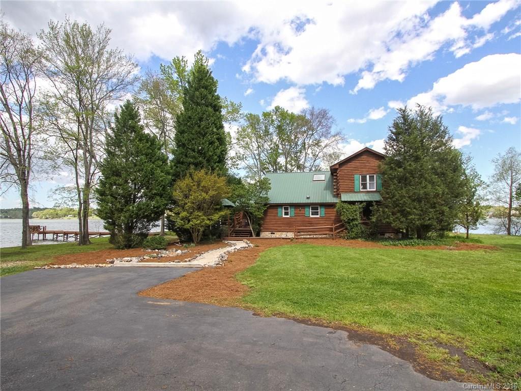 Breathtaking Waterfront Panoramic Views!! Charming Log Cottage/Cabin on Gorgeous Peninsula 1.14Ac Lot Features Open Floor Plan, Exposed Log Beams, Cathedral Ceilings, Skylights, Stone Fireplace, Knotty Pine Flooring/Walls/Ceilings, Built-ins! Relax by the Chiminea on the Sandy Beach, Enjoy Beautiful Sunrises & Sunsets!!  This Magnificent Lakeside Haven Retreat is an Awesome Place to Call home!! Convenient Location near Charlotte/Lake Wylie/Surrounding areas.