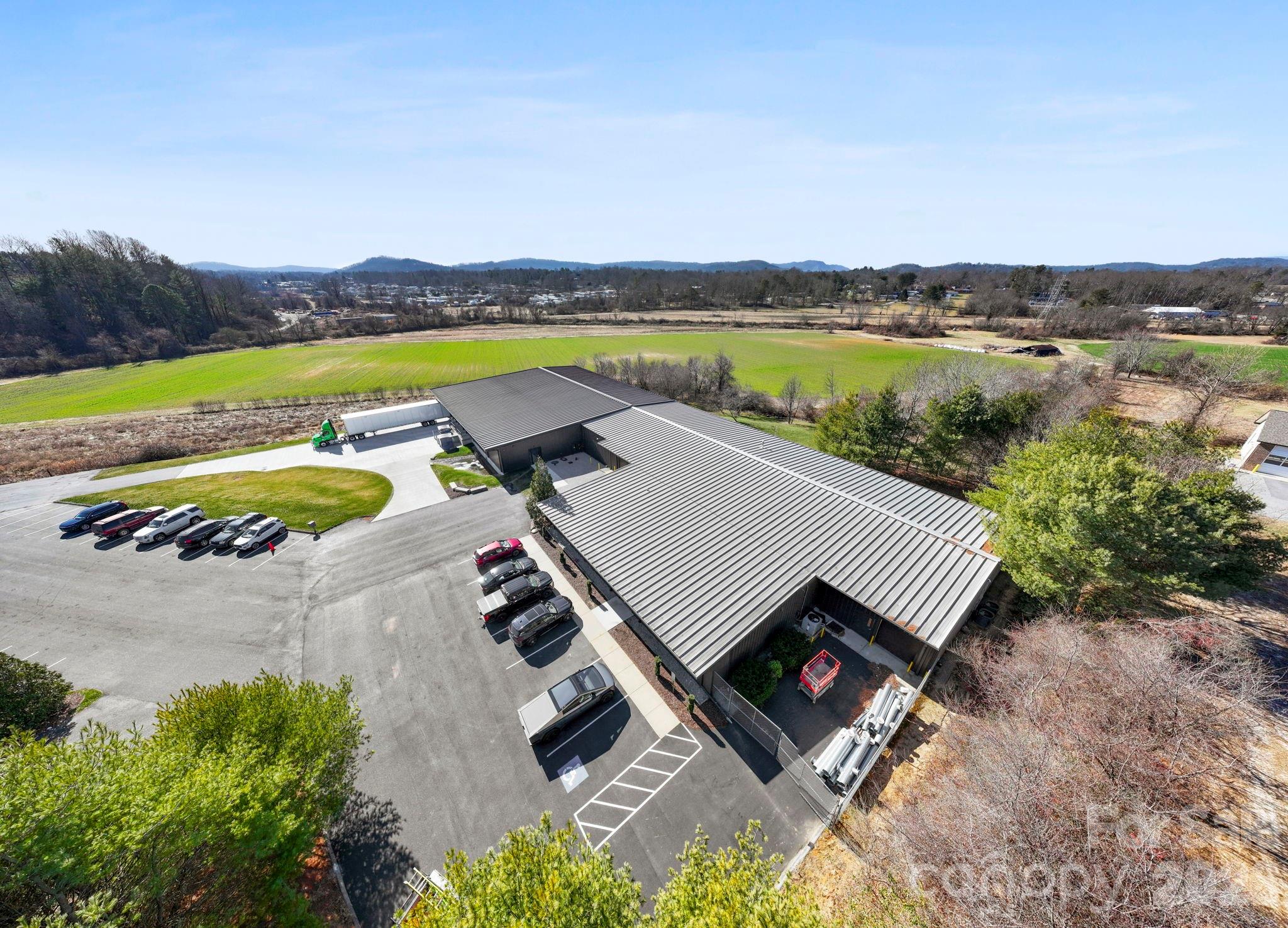 Move in Ready! 24,000 SF Modern Industrial Facility | Prime I-26 Location | Appleland Business Park | Hendersonville, NC This 24,000-square-foot industrial facility is strategically located in the Appleland Business Park, one of the most active and fastest-growing commercial districts in Hendersonville, North Carolina. Positioned just off Interstate 26 at Upward Road, the property offers exceptional local and regional connectivity, making it ideal for manufacturing, distribution, logistics, or owner-operator users seeking efficient access throughout Western North Carolina and the Southeast. The building consists of approximately 12,000 SF constructed in 2001, with an additional 12,000 SF expansion completed in 2025, delivering modern construction, updated systems, and a highly functional layout. Improvements include approximately 3,000 SF of office space and 21,000 SF of clear-span warehouse, providing open-concept flexibility for a wide range of industrial operations. Infrastructure features include three-phase power with 800 amps, natural gas, two loading docks, and one overhead drive-in door, supporting high-power and logistics-intensive users. The entire facility is fully climate-controlled, ADA compliant, and equipped with a new bi-directional amplifier (BDA) system, enhancing operational reliability and safety. The site offers 40 striped parking spaces, with additional land available for expanded parking or future operational needs. The location provides immediate access to Asheville, Greenville, and Spartanburg, positioning the property within a strong regional distribution corridor serving Western North Carolina, Upstate South Carolina, and beyond. With modern expansion, high electrical capacity, dock-high loading, and proximity to major transportation routes, this is a rare opportunity to acquire a move-in-ready industrial asset in one of Hendersonville’s most desirable and rapidly developing business parks. Strategically located just off Interstate 26 at Upward Road, the property provides excellent access for deliveries, regional distribution, and employee commuting. This is a rare opportunity to acquire a modern, high-capacity industrial asset in a premier business park with immediate interstate access and strong long-term growth fundamentals.