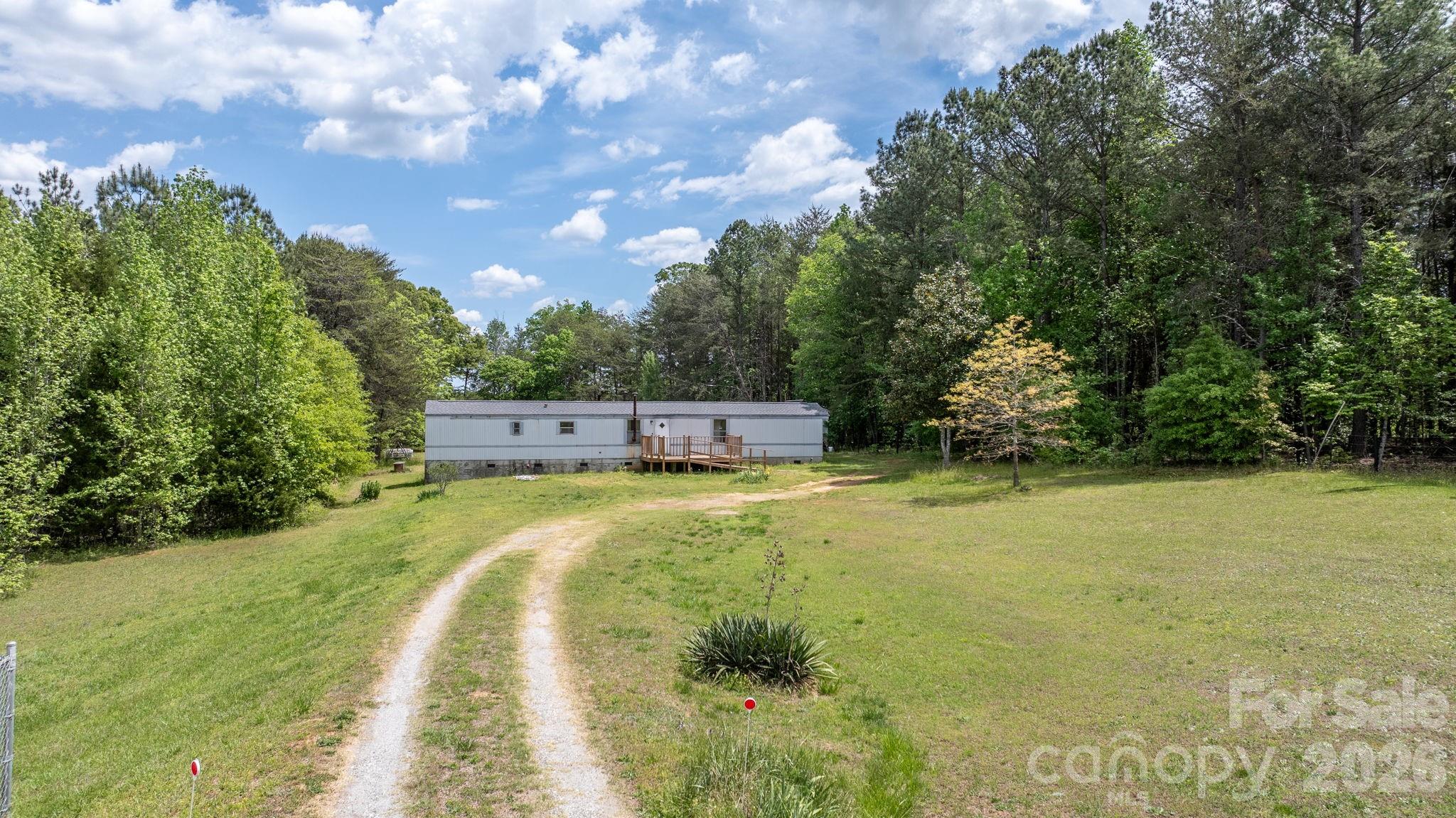 Situated on approximately 2 acres in a quiet rural setting, this 3-bedroom, 2-bath manufactured home offers a great opportunity for investors or buyers seeking space and privacy. The home features a functional layout with a spacious living area, kitchen with dining space, and split bedroom design. Enjoy the freedom of no HOA and plenty of room for outdoor activities, parking, or future improvements. Conveniently located with easy access to Cherryville, Lincolnton, and surrounding areas. Property is being sold as-is and offers excellent potential for renovation, rental, or replacement with a new home.