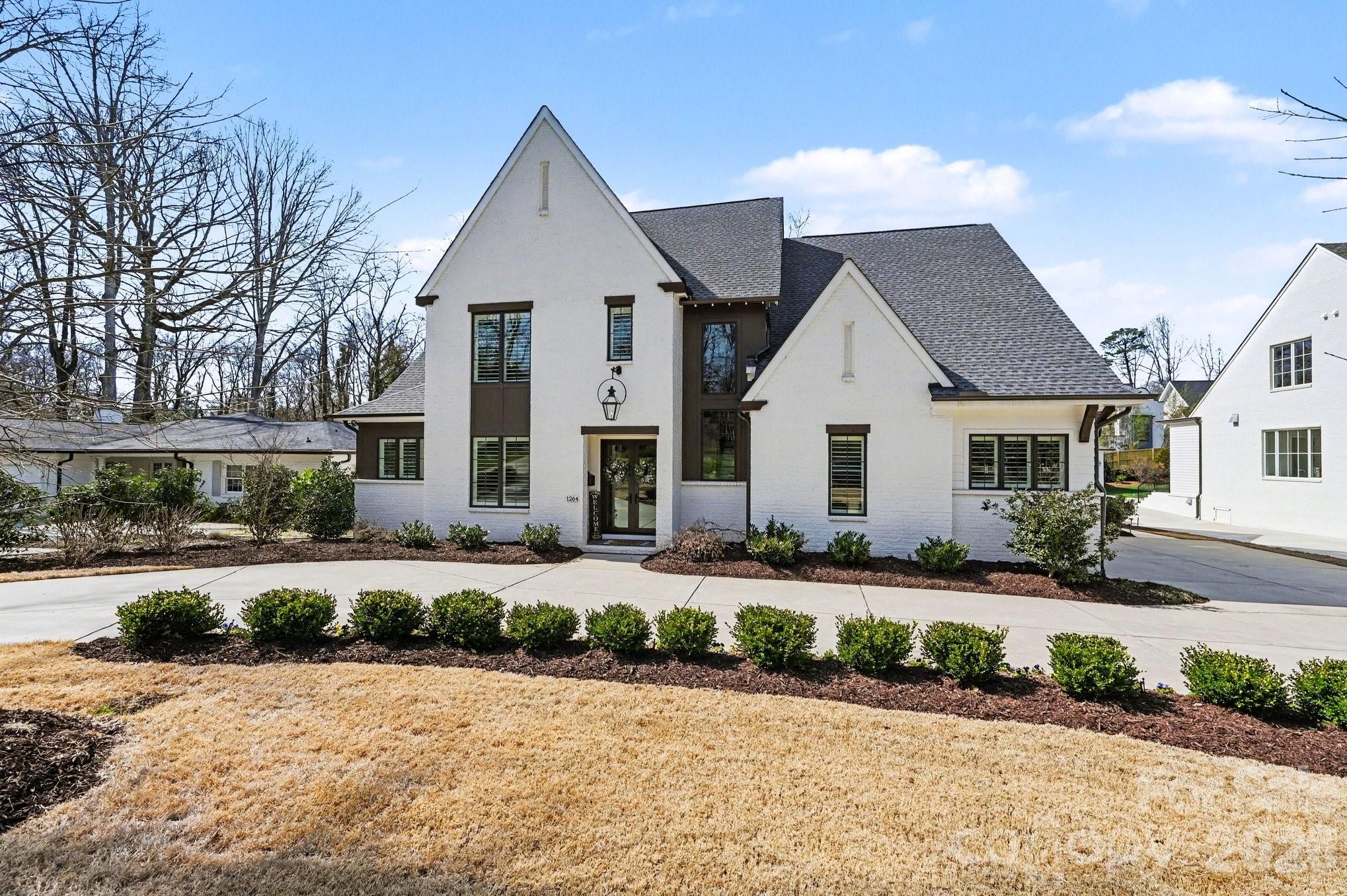 STUNNING, MOVE-IN READY, CUSTOM BUILT HOME in sought after Providence Park. Experience exceptional craftsmanship and modern elegance in this newer constructed 5 bedroom, 5 full bath, and 2 half bath luxury residence with 3 car attached garage designed for both grand entertaining and everyday comfort. A dramatic two-story entry welcomes you into a light-filled interior, showcasing rich hardwood floors throughout and a seamless open-concept layout for the main living space. The chef's kitchen is a true showpiece, featuring a large quartz island, tiled backsplash, upgraded stainless steel appliances, and is close to a conveniently located drop zone. Just beyond, a fully outfitted scullery offers custom cabinetry, quartz countertops, a wine refrigerator, and a spacious walk-in pantry - perfect for effortless hosting. The living room impresses with a coffered ceiling, custom built-ins, and an inviting fireplace. A private main-level office with built-in shelving and storage cabinets, provides the ideal work-from-home retreat, while plantation shutters in every room add timeless sophistication. The main-level primary suite is a serene sanctuary, highlighted by vaulted ceilings and a spa-inspired bath with beautifully tiled shower. A spacious custom walk-in closet connects directly to the main-level laundry room for convenience and everyday ease. An elevator ensures easy access to all levels. Upstairs, you'll find four additional generously sized bedrooms, each with its own private full bath, offering comfort and privacy for family or guests. A huge bonus room serves as the ultimate gathering space, complete with a custom built-in bar featuring quartz countertops, a sink, and a beverage refrigerator-perfect for entertaining. An additional laundry area adds practicality and thoughtful functionality. Step outside to your private resort-style oasis: a fully fenced backyard surrounds a custom in-ground pool and hot tub, all viewed from the back porch with retractable screen that transforms the space into an open-air retreat. This extraordinary home blends luxury finishes, thoughtful design, and high-end amenities to create a truly elevated living experience. Conveniently located between Southpark and Cotswold, near to shopping and restaurants and a short drive to Uptown. Also close to Charlotte Christian, Providence Day and Charlotte Country Day schools.