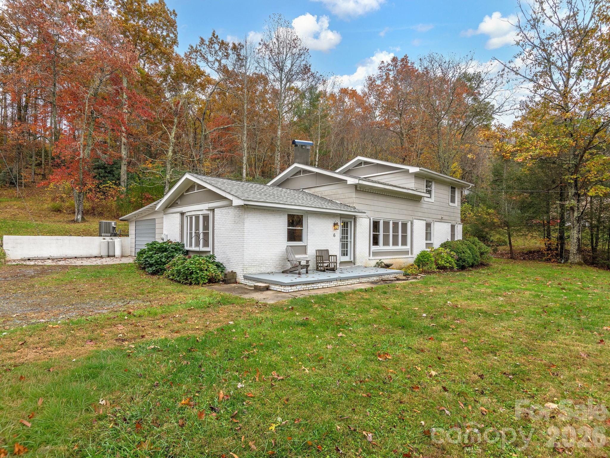 FAIRVIEW BEAUTY ON 2.58 GORGEOUS, USABLE ACRES WITH NEW ADDITION & TURNKEY UPDATES! Exceptionally maintained and thoughtfully renovated 4BD/3BA home offering 2,834± sq ft of comfortable, flexible living in peaceful Fairview. Designed for both everyday ease and effortless entertaining, this home features a serene main-level primary suite and an inviting open floor plan enhanced by rich hardwoods and radiant heated tile floors. The newly renovated gourmet kitchen is a true centerpiece, showcasing granite countertops, double ovens, and a gas cooktop perfect for gathering and creating memorable meals. A spacious addition offers incredible versatility with options for a home office, media room, playroom, and private ensuite guest quarters. Generous secondary bedrooms and updated baths in the original home provide comfort and privacy for family and guests alike.
Major system updates including a new roof, HVAC, and expanded four-bedroom septic system ensure peace of mind and truly turnkey living. Set on 2.58 beautiful, usable acres, the property offers endless possibilities for outdoor living, gardening, or simply enjoying the privacy and tranquility of Western North Carolina. A rare Fairview gem that's move-in ready and waiting to welcome you home. Short-term rentals permitted!