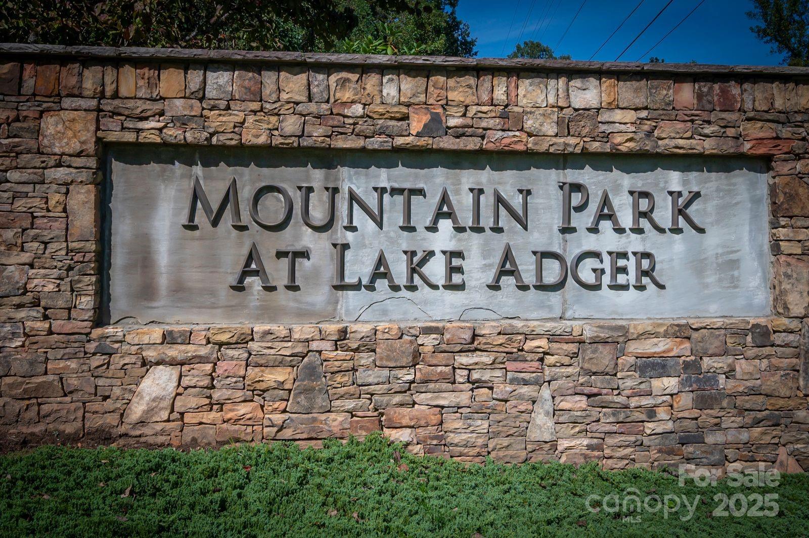 Welcome to Polk County's secret! Fabulous Lot 29 is located in the gated Mountain Park at Lake Adger.  This 11.70 acre lot offers private lake life. Wooded lot offers several building sites surrounded by trees and offers you a perfect spot for the forever or second home. Lot has driveway access after immediately crossing a beautiful bridge. Deeded boat slip at the Mountain Park Marina—get your watercraft ready for fishing and sunsets. Lake Adger has 14 plus miles of shoreline with many equestrian and hiking trails. Also, offers convenience to Columbus, Tryon and other cities.
