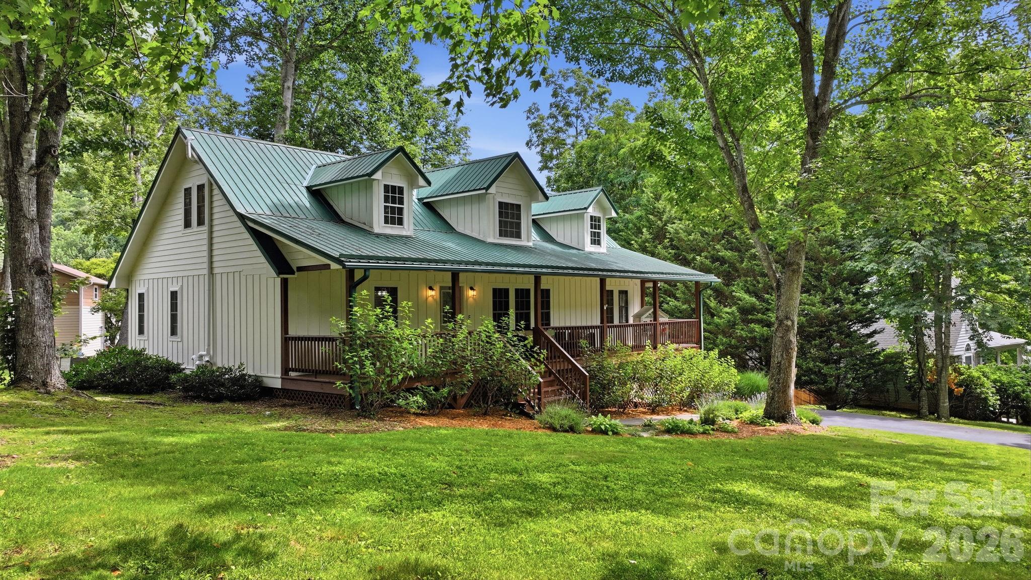 Welcome to this beautifully maintained 4-bedroom, 4-bath mountain home nestled in the highly desirable Brannon Forest community.  Offering the perfect blend of modern comfort, mountain charm, and exceptional curb appeal, this spacious home is ideal as a full-time residence or second home retreat.

Enjoy peaceful mornings on one of two porches overlooking lush green space, where a gently flowing creek borders both the front and back of this property. Relax to the sounds of rushing water, rustling trees, and abundant wildlife in this serene mountain setting.

Inside, the thoughtfully designed split-bedroom floor plan features a spacious layout with a fully finished basement, providing flexible living space for guests, recreation, a home office, or multigenerational living. Every detail has been carefully considered to create a warm, inviting atmosphere.

Brannon Forest offers outstanding community amenities just a short walk from your front door, including a clubhouse, community garden, playground, pond with picnic space, and the neighborhood's beloved pet donkeys, Doc and Daisy.  Residents enjoy a welcoming mountain community with year-round activities and a true sense of neighborhood. Paved access all the way. 
Conveniently located just 10 minutes from Maggie Valley and approximately 15 minutes from downtown Waynesville, you'll have easy access to local restaurants, shopping, festivals, golf, hiking, waterfalls, the Blue Ridge Parkway, and the Great Smoky Mountains. Whether you're searching for a primary residence or mountain getaway, this exceptional home truly checks all the boxes.