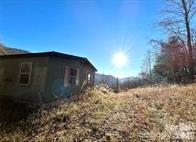 Part of an old farm. MOUNTAIN VIEWS ! 
Located Off Hwy 209 , Betsy’s Gap road , Clyde ; Hard to find 28.11 acres with improvements ; has beautiful Mountain Views, partial fencing,( 4 acres of pasture w/ shed ) 2 springs , and is UNRESTRICTED.  Checkout the Long range views, private corner lot, older MF home stays ( personal property, Being sold AS IS ) needs repairs , OR build your dream home here! Has gravity flow Spring water,(Needs hooked back up)  lower part of the Land is rolling/ somewhat sloping, some hilly,  Mountain is steep but has old winding trails. Septic in place, electric in place, road to homesite in place, Also has additional approved septic perk certificate located below the present home site  ( lower area of land ) Lots of possibilities! Old MF home is personal property; Can be refurbished or town down and build here! At least two good Home sites. Disclosure: Listing agent is related to some of the sellers. 

Come own Your very own mountain today!