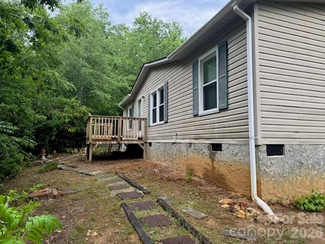 Buyers & Investors Alert!!  Private Location off Whitaker Road in Cool Fairview! Affordable 2002 manufactured home that is ready for a few updates to make it your own! Or investors to flip --- has quick update/flip potential.  Open Living & Kitchen Plan, Split Bedrooms with 2 full baths.  Primary bath has a large garden tub & separate shower. Separate Utility space off the kitchen from back deck entrance.  Washer & Dryer conveys.  Newer windows & Hot Water heater.  Electric HVAC for heat & AC  Large detached Carport for tandem vehicles or RV. Carport has Water & Electric. Cleared back yard area.  NO HOA discovered!  Open Use (buyer to confirm) & nestled between nice subdivisions, but not in formal subdivision. Cute storage shed & 2 decks.  Located in the Fairview countryside but approx. 5-6 miles to Charlotte Hwy & about 6-7 mlles to Fairview Food Lion, Library, Fairview Elementary & Post Office!  Easy, commutable distances to I-40, Asheville, Fletcher, Arden & I26,