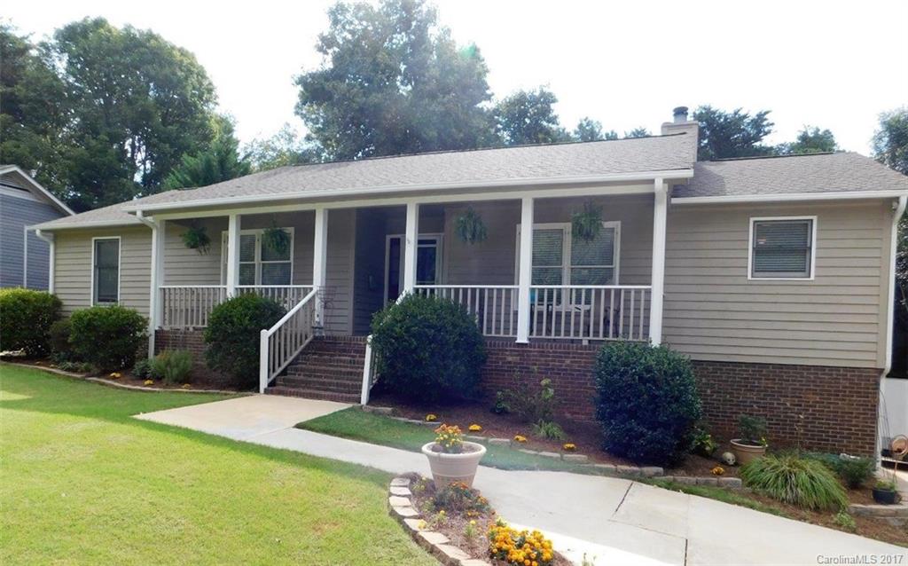 Enjoy Tega Cay's vacation lifestyle in this beautifully updated & spacious 4 BR/3 BA home with 3300 square feet! Open concept LR, DR & Kit w/granite and SS. Master on main with newly renovated master bathroom. Lower lever features family/bonus room with 2nd fireplace, guest suite, flex space/home office, mud room, 10x20 workshop. Home backs to 7 acres of woods with walking trails, large private yard w/patio, large deck & 10'x16' shed. Just steps from Pitcairn Park on beautiful Lake Wylie.