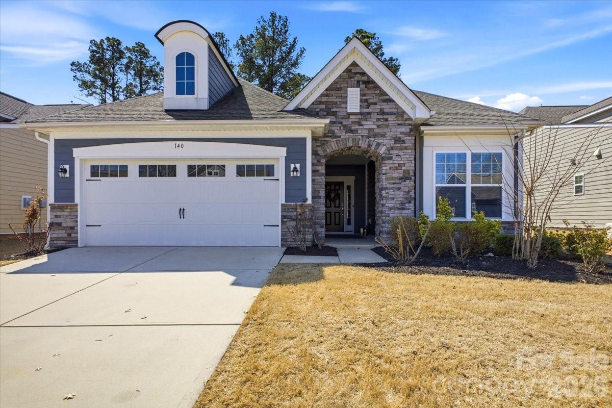 140 Picasso Trail is situated on a quiet cul-de-sac street within the active adult community of Imagery on Mountain Island Lake.  The open concept "Bliss" floor plan offers a great room with built-in cabinets, a gas fireplace, granite countertops and a master suite with a large tiled shower. Additional included features are a sunroom, a screened in porch & a large added paver patio with a custom built in grill and separate firepit. The Community features a beach, clubhouse, pool, fitness center and many other amenities. Lawn Maintenance included!
