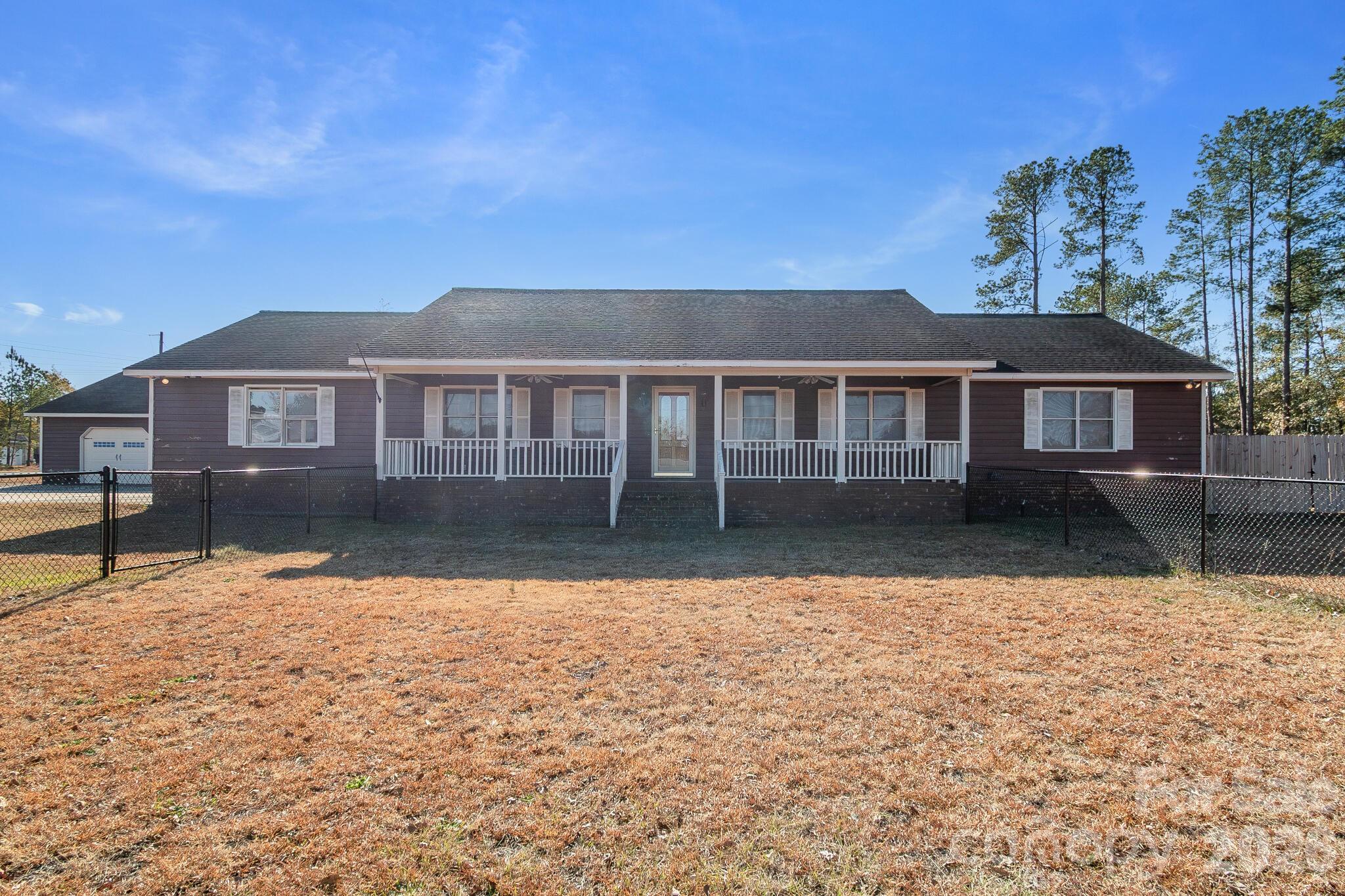 Back on Market ~ no fault of the sellers!

Welcome home to this inviting 3-bedroom, 2-bath home situated on over an acre in a quiet, convenient Cheraw location. Enjoy a spacious fenced yard with both single-gate and double-gate access for pets, equipment, or outdoor projects. The property includes an oversized 40×50 garage with 110/220 power vehicle for a mechanic or hobbyist and a two-car attached carport. Energy efficiency shines with paid-off solar panels, keeping average electric bills under $30 per month. Inside, the home has an open layout, abundant natural light, and comfortable living spaces. A blend of privacy, practicality, and location and just minutes from town conveniences.