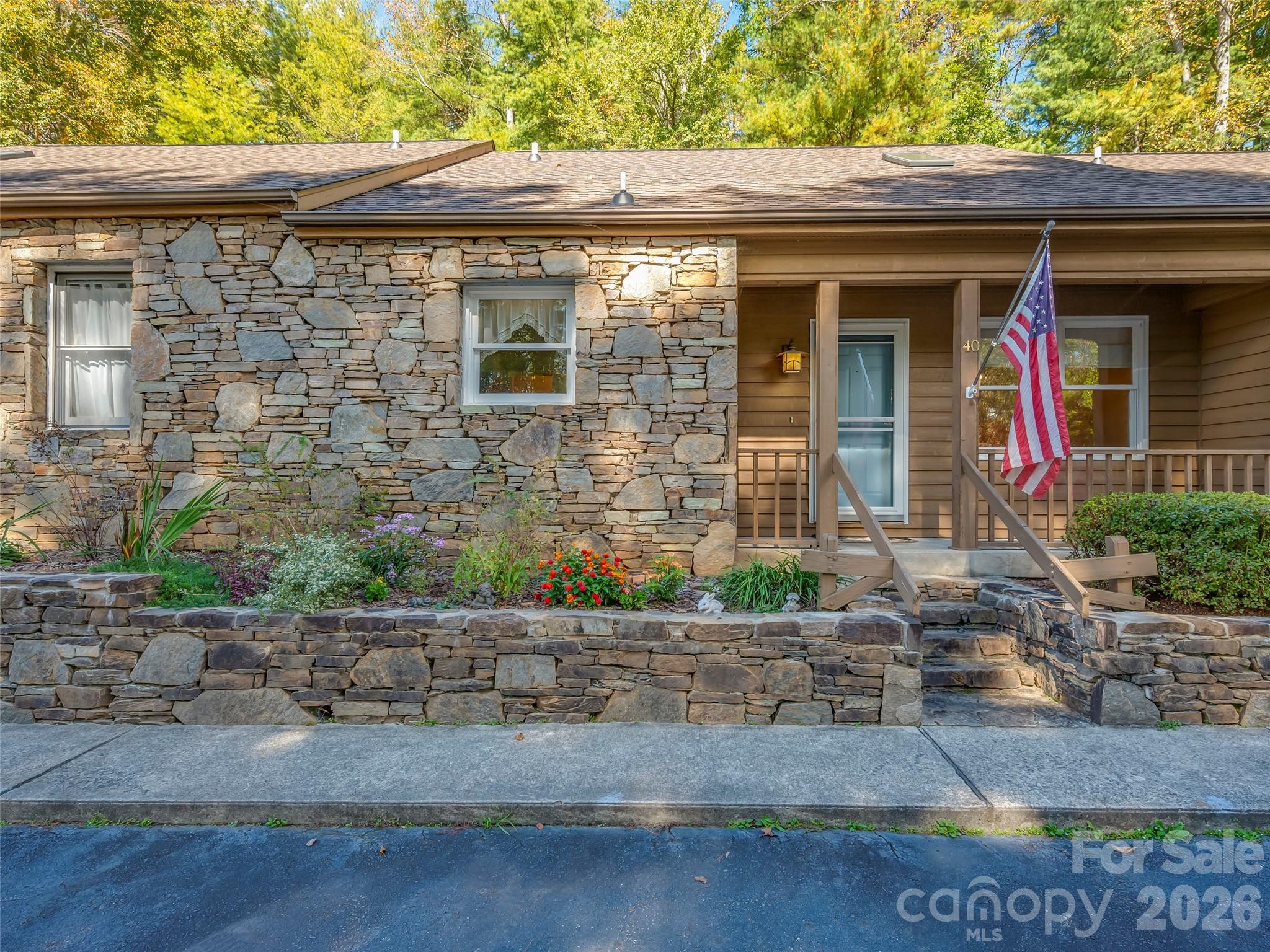 Lovely condo close to the Etowah Golf Course! Experience effortless living in this beautifully maintained home offering spacious rooms and abundant natural light. The expansive screened porch overlooks a serene wooded backdrop, creating the perfect space for morning coffee or evening relaxation. Designed for comfort and flexibility, this home features two primary suites—one on the main level and an impressive second-level retreat that occupies the entire upper floor. The upstairs suite offers exceptional space, privacy, and versatility, has been used as a bedroom, and includes a private office area—ideal for remote work or a cozy reading nook—along with generously sized walk-in closets. Recent updates include a new roof and skylights (2025), adding both style and peace of mind. Enjoy a low-maintenance lifestyle with access to a community pool, all conveniently located near golf, dining, and everything Etowah has to offer