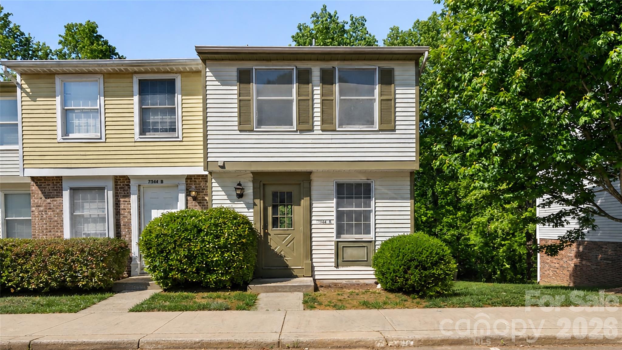 Highly sought after end unit with walk out basement priced below $200,000 and below tax value! Great opportunity for home ownership and to build up your own sweat equity! Prime location in the community with serene creek side view and open common area beside and behind unit. No neighbor view directly behind unit!  Brand new interior paint, brand new carpet in unit, and brand new 2026 water heater! The front door opens to an inviting entrance foyer with convenient coat closet and half bathroom for main level. The open main level floor plan offers a spacious dining room and living room combination with large picture windows providing abundant natural light. Private tree top views capture your eye from the main and second level. The efficient kitchen offers a large pass through window to the dining room and would be easy to update in the future. The desirable basement provides finished flexible space to suit your personal needs – home office, second den, work out room, lots of possibilities. The basement has both interior and exterior access to the unit and features a large recreation room, spacious walk in storage closet, utility room, and great storage under the stairs. Upgraded Trane Heat Pump with 2014 AC Compressor and 2006 indoor unit. Upstairs you will find a private primary bedroom showcasing dual closets, separate dressing area with mirror and vanity, and direct access to full bathroom. Spacious secondary bedroom with ample closet space and nice view behind the unit. The rear backyard is fenced and has gate leading to bordering HOA common area to romp, roam, play, and explore. This property comes with two assigned parking spaces directly in front of the unit - both marked 7344A.
