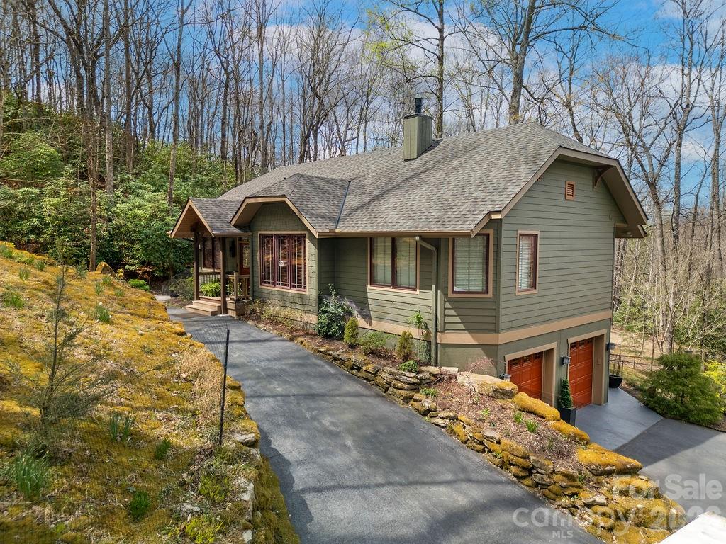 Discover a meticulously maintained sanctuary set on 2.38 private acres, bordered by two babbling creeks in the highly sought-after Glen Cannon community. Perfectly positioned just minutes from Downtown Brevard and the entrance of Pisgah National Forest, this home is the ideal launchpad for mountain biking, hiking, and trout fishing enthusiasts.

Step inside a main level that floods with natural light, offering the serene feel of living in the treetops. The open-concept interior features vaulted ceilings and expansive windows. The renovated primary suite is a true sanctuary, featuring a spa-like walk-in shower, custom storage, and heated tile floors. The chef’s kitchen is designed for entertaining, flowing effortlessly into the dining space and living area anchored by an inviting fireplace.

The real showstopper? The Treetop Screened Deck. Experience mountain living on a massive scale, upgraded with a brand-new 50-year shingle roof, new skylights, and remote-controlled shades for year-round comfort.

The flexible lower level offers a third bedroom, full bath, and versatile flex space—perfect for a home office, guest suite, or recreation room. Plus, the oversized 2-car garage provides ample storage for kayaks, bikes, and all your outdoor gear.

Experience the peace of the mountains with the convenience of Brevard at your doorstep. This is one you truly have to see! Be sure to view the video tour for a virtual walkthrough of this treetop sanctuary.