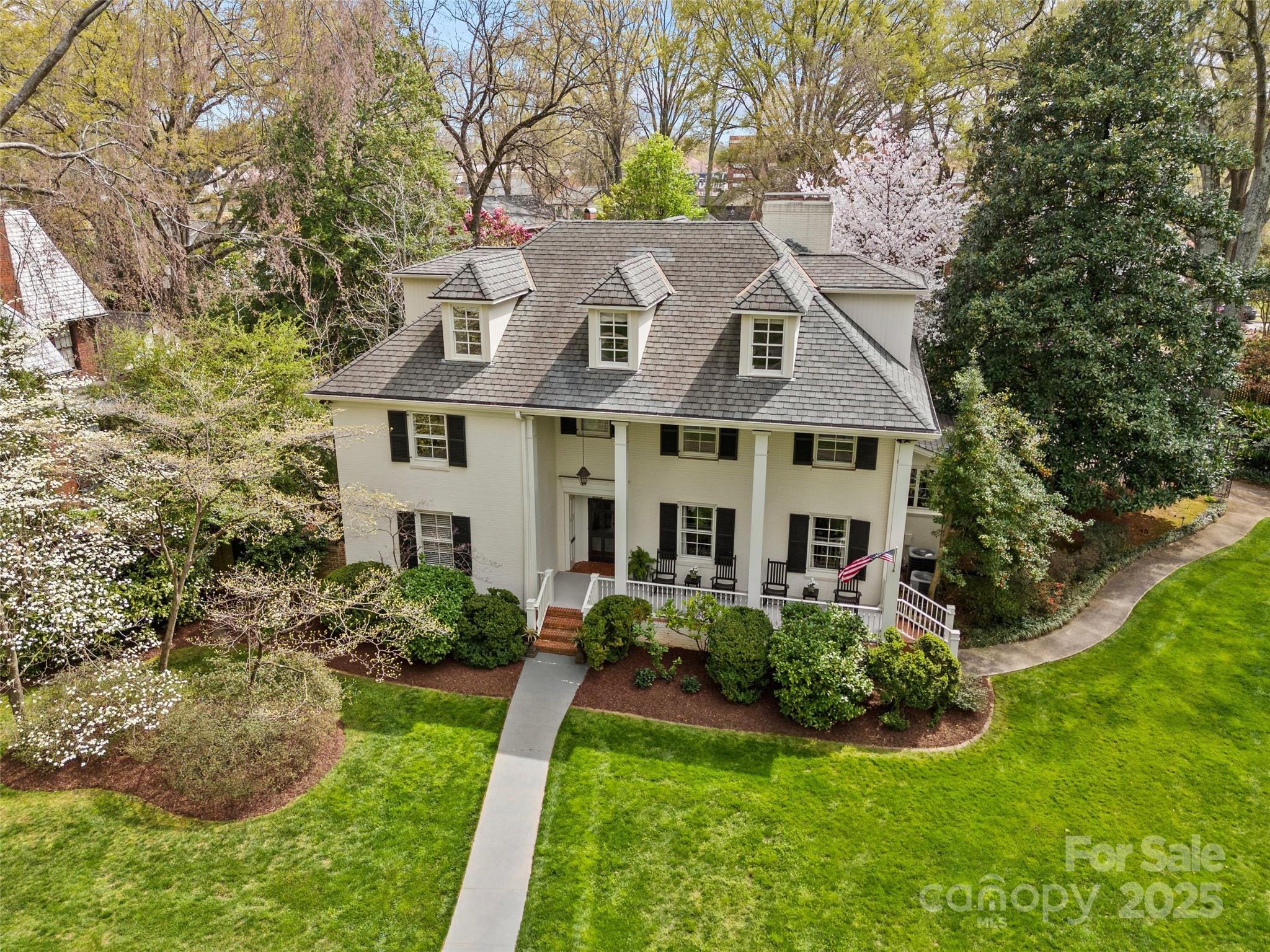 Nestled on a coveted half-acre corner lot on prestigious QRW, this exquisite residence flawlessly blends timeless charm with modern sophistication. An inviting rocking chair front porch sets the stage for the opulence within. Encompassing 5,000 sq ft, the home includes 4 bedrooms and 4 full baths, with a versatile main floor office and bath that can serve as a fifth bedroom. The chef’s kitchen, a masterpiece by Frank Smith, features a SubZero fridge, Wolf range, scullery pantry, additional dishwasher, and a temperature-controlled wine room. Luxurious hardwood floors, refined moldings, and a wood-paneled den with gas fireplaces enhance the living spaces, fostering a welcoming atmosphere. The formal dining room seamlessly transitions to an outdoor patio. The primary suite is a retreat with steam shower and concealed walk-in closet. A covered rear patio overlooks a tranquil backyard with a brick wall, ideal for relaxation. Plans for a pool, garage, and cabana by Frank Smith are available.