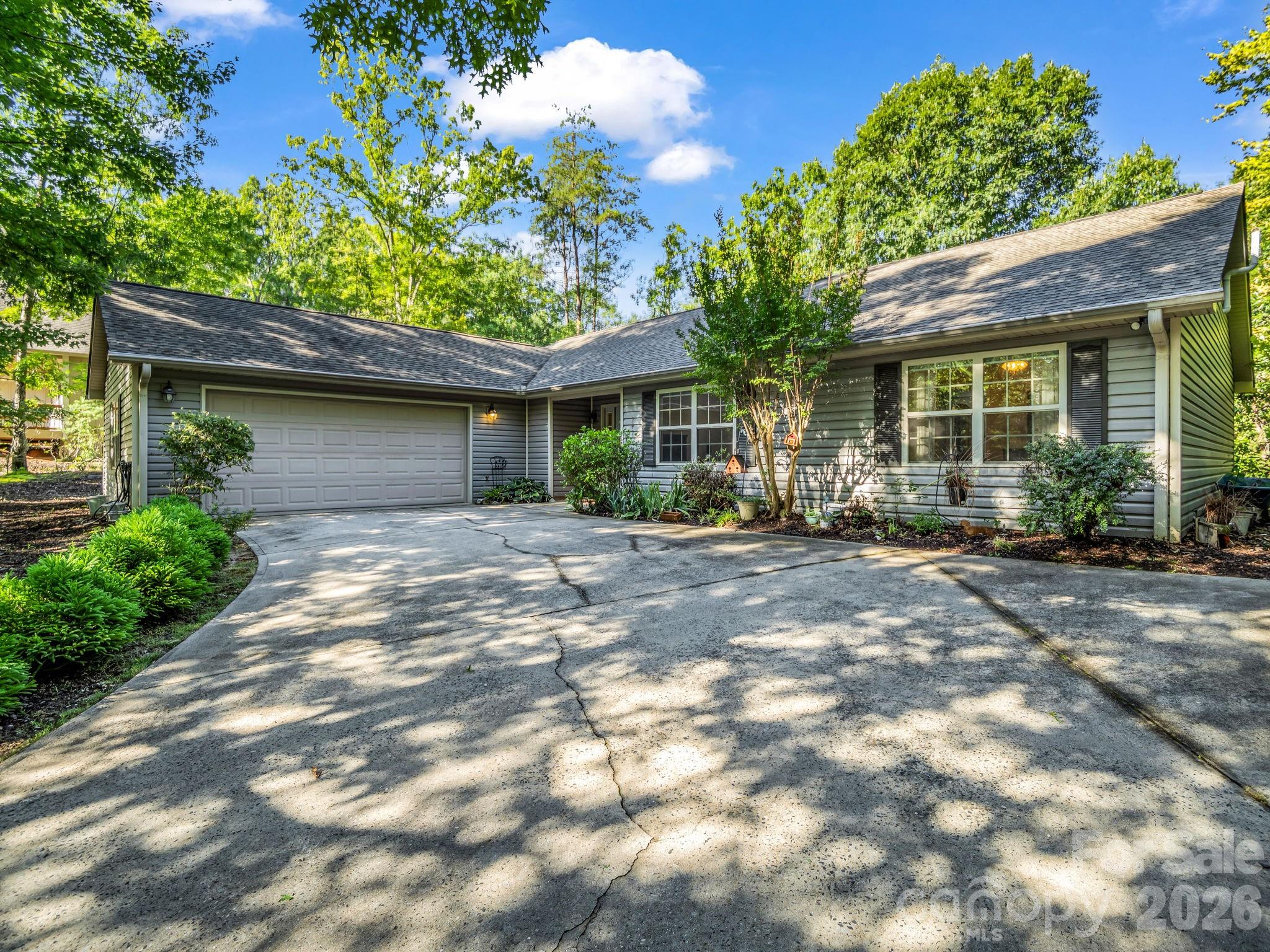 Immaculately maintained single-level home nestled in the heart of Shumont Estates within Rumbling Bald on Lake Lure. Thoughtfully designed with an open-concept floor plan, this inviting residence features a beautifully updated kitchen with a spacious center island, breakfast bar, and seamless flow into the living and dining areas—perfect for everyday living and entertaining. Rich hardwood floors extend throughout the home, adding warmth and timeless appeal.
The expansive primary suite is a true retreat, complete with a tray ceiling, walk-in closet and tons of storage, and a luxurious ensuite bath featuring a massive walk-in shower. Two additional generously sized bedrooms provide comfortable accommodations with adjacent full bathroom. 
Outside, enjoy the peaceful natural surroundings from the private back patio, an ideal space for grilling or relaxing. A two-car garage with lots of storage, ample guest parking, and a low-maintenance yard make this home as practical as it is beautiful. For added peace of mind, the property includes a radon mitigation system and a portable gas generator. Whether you're seeking a full-time residence or a mountain getaway, this meticulously cared-for home offers comfort and convenience. Community amenities include two golf courses, private beach, lake access, restaurants, salon & spa, fitness center, tennis courts & more! **Furniture negotiable**