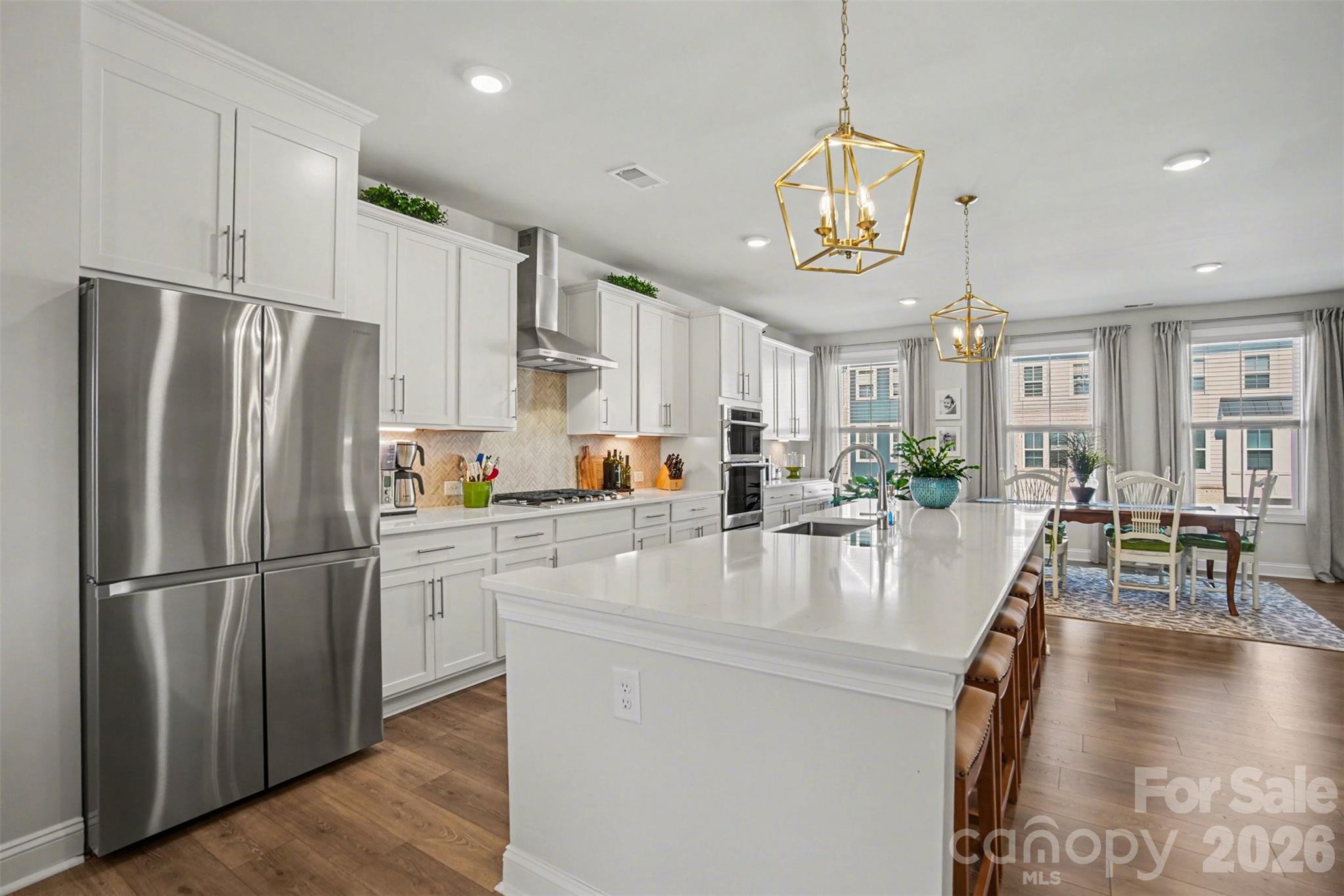 NEW ADJUSTED PRICE!!!  Beautiful newer construction luxury townhome located in Indian Land! This energy-efficient home has the perfect layout, featuring a large bonus area/office/bedroom on the ground floor with a full bathroom and large closet and access to a covered back patio area. The second level is the heart of the home with open floorplan and tons of natural light. The dining area and spacious gourmet kitchen open to a cozy living area with fireplace and access to a large screened patio. There is a convenient office nook and half bath as well. The kitchen is truly a dream with a huge island with gorgeous quartz countertops, a large stainless farmhouse sink, tons of cabinets and a walk-in pantry. The stainless appliance package includes a 36" gas cooktop and a smart microwave and convection wall oven. Retreat to the third level to a large primary bedroom complete with a large walk-in closet and beautiful ensuite bathroom with double quartz vanities and a large tile shower. The additional two bedrooms, full bathroom and laundry room make this floor a private and quiet getaway. Tankless water heater and smart home features add to the efficiency of this home.  This home is $176 a Sq Ft!! Comparable homes are $200+ a Sq Ft!! You really must see this home!!