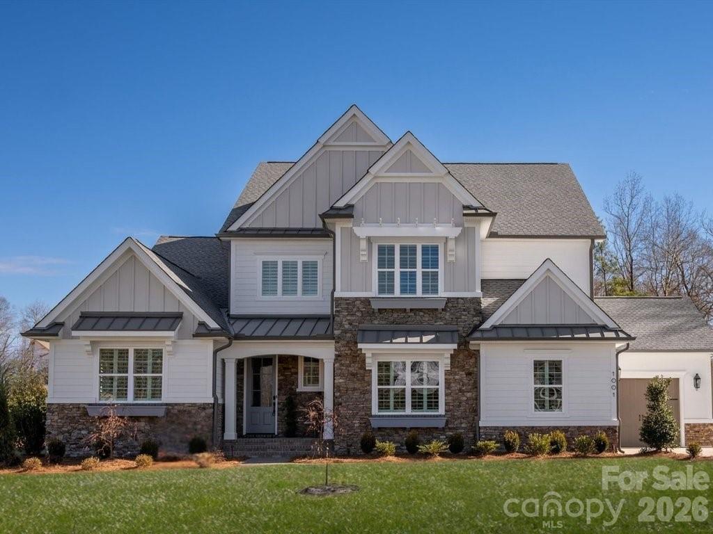 Fall in love with this beautiful American Cottage home by Charlotte's locally owned, and nationally recognized luxury homebuilder. Move-in ready for October and located in the McLean South Shore community. Awarded "Best Floorplan in the Country", the Monterey explodes with personality. Inspiring oversized kitchen and spacious Great Room with vaulted ceiling. A Dining Room with stacking sliding doors, opens to the Outdoor Living Room, blurring the line between indoor/outdoor spaces. The Main Level Primary suite boasts a vaulted ceiling and is separated from the living area with a vestibule and hallway, ensuring privacy. The Primary bath spa atmosphere is sure to delight. Upstairs, a large Bonus Room and three bedrooms with walk-in closets and ensuite baths are tucked away off of a private hallway.