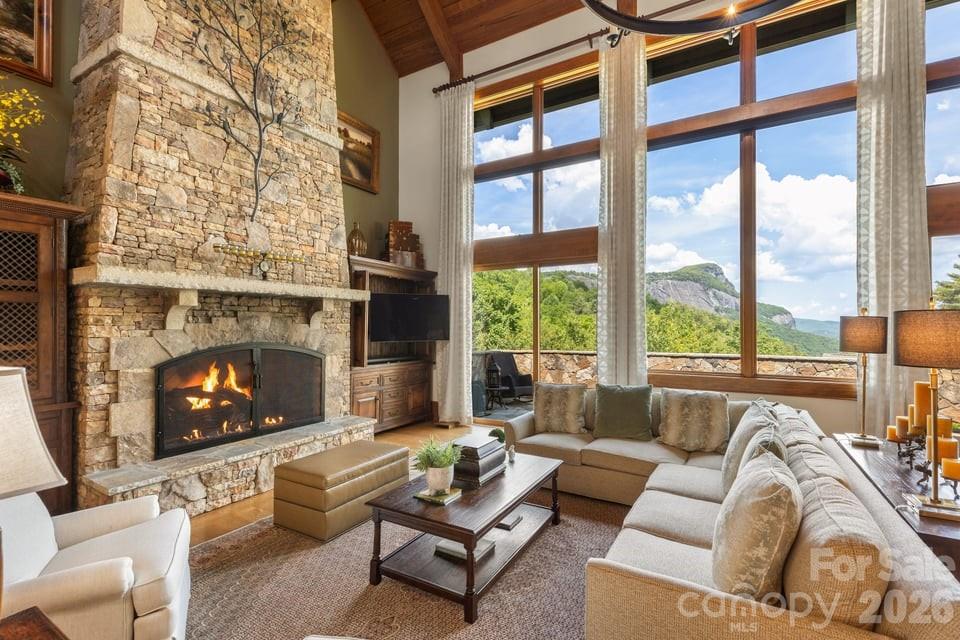 Cullasaja Club luxury home with breathtaking Whiteside Mountain views in Highlands, NC. Built in 2007, this beautifully designed residence offers a rare opportunity within one of the Highlands-Cashiers Plateau’s premier gated golf communities, featuring an Arnold Palmer-designed course and exceptional lifestyle amenities. Situated on approximately 1.61 acres, the property is enhanced by professionally designed natural landscaping that blends seamlessly with the mountain setting while providing privacy. The home features four ensuite bedrooms, including two that function as primary suites, offering flexibility for a variety of living arrangements. With five full baths and one half bath, the layout is designed for both comfort and convenience. The main living area showcases a dramatic stone fireplace, vaulted ceilings, and expansive windows that capture the long-range Whiteside Mountain views. Natural light fills the space, highlighting the craftsmanship and warm finishes throughout. The spacious kitchen is well-appointed with abundant cabinetry, quality finishes, and a large center island, ideal for entertaining and everyday living. Open flow between the kitchen, dining, and living areas creates a seamless and inviting environment. A standout feature of the home is the dedicated entertainment wing, complete with a bar, pool table area, and a personal movie theatre—providing a private space for recreation and hosting. Outdoor living includes a stone patio surrounded by thoughtfully designed landscaping, offering a peaceful setting to enjoy the mountain air and scenery. Cullasaja Club amenities include a championship golf course, clubhouse with dining, fitness center, tennis and croquet, and access to scenic trails and Ravenel Lake. Membership is subject to club approval. This Highlands, NC luxury home offers an exceptional blend of mountain views, flexible living spaces, and resort-style amenities. Schedule your private showing today.