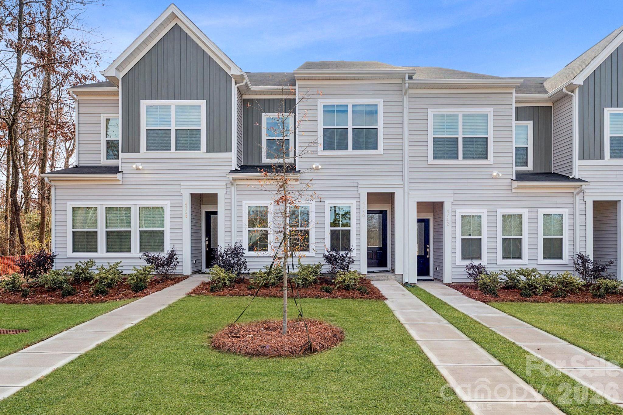 Beautifully designed and thoughtfully crafted, this north-facing Cannalily townhome offers 3 bedrooms, 2.5 baths, and a light-filled open-concept layout perfect for modern living. The kitchen showcases Burlap colored cabinets, white backsplash, Quartz countertops, a spacious sitting island, stainless steel GE electric appliances, and luxury vinyl plank flooring throughout the main level. Upstairs, the spacious primary suite features a boxed ceiling, a walk-in closet, and a private bath with dual vanities and a tiled walk-in shower. A nearby laundry closet adds everyday convenience, while two additional bedrooms and a full bath complete the second floor. Additional features include a rear-entry one-car garage and a built-in bench and cubby system just inside the entry—ideal for storage and organization. With smart design, 9' ceilings on both floors, quality finishes, and low-maintenance living, the Cannalily plan blends style and functionality in every detail! Ask about Move-in package Promotion! 2025 Parade of Homes GOLD Winner!