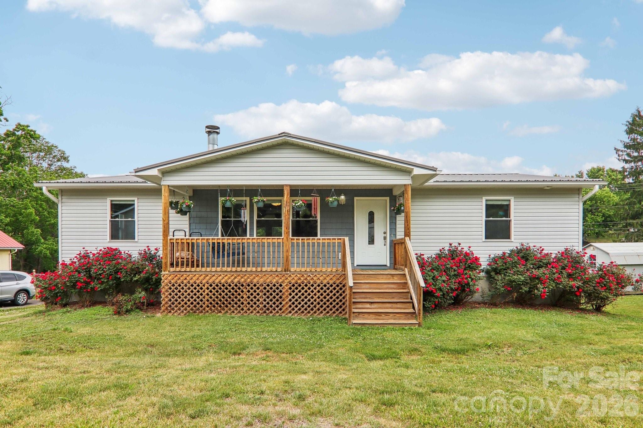 What a wonderful quaint home on a spacious fenced lot..! This was the original builders home… In a small mountain town in Haywood County near Asheville. The home has 3 beds and 2 baths,porches, granite, breakfast island and bamboo flooring and sits in an established neighborhood with convenient access to downtown Canton, local schools, shopping, and outdoor recreation opportunities in the surrounding Blue Ridge Mountains. The area offers a blend of historic homes, mature trees, and a quiet residential atmosphere.  Plenty of storage under the basement/giant usable crawl space.

The yard is a blank canvas for those with landscape visions.  Walkways and gardens are waiting to be created. The driveway is half asphalt and half gravel.  The gravel has disappeared under grass and partially washed away but can be re done with all the landscape visions. I’ve attached an AI idea for a walkway.  Also, the lower portion of the home has road access for a back yard driveway or shed to added.

Properties along Trammell Avenue are generally valued for their proximity to community amenities while maintaining a sense of privacy and small-town charm. Nearby homes feature modest lot sizes and a mix of traditional architectural styles common to Canton’s historic residential districts. 

Residents enjoy easy access to hiking, fishing, and scenic drives, while remaining within commuting distance of Asheville. Overall, 527 Trammell Ave represents a property in a convenient, community-oriented location with strong appeal for homeowners, retirees and investors