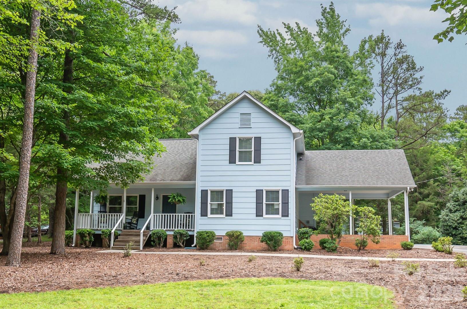 Welcome home to 7012 Knotty Pine, your own slice of serenity! This meticulously maintained home is truly move-in ready and just minutes from the heart of Waxhaw on a peaceful quiet street. The moment you arrive, you'll be drawn to the deep front porch that overlooks an amazing front yard, while the back deck offers stunning views of a sprawling yard with the perfect combination of sunshine and shade. Step inside to discover a wonderful space for entertaining, featuring a large living room with soaring vaulted ceilings that transitions seamlessly into the dining room, all enhanced by gorgeous new flooring and fresh paint throughout. The updated kitchen is spotless with it's new quartz counters, subway tile backsplash, and stainless LG appliances, while the primary bedroom on the main level offers both a walk-in closet and smaller closet plus a beautiful en-suite bathroom. Upstairs, you'll find charming spaces including two generously sized bedrooms and a loft area with a huge storage closet, providing plenty of room for family or guests. The thoughtfully positioned carport makes carrying groceries into the kitchen on rainy days a breeze, and the oversized outbuilding is ready to serve as your work-from-home office, the ultimate workshop, or storage for all your belongings.  This one has been meticulously maintained, and sports a new HVAC (2023) and new well pump and filtration system (2025).This magical property truly offers exceptional value and is ready to welcome you home!