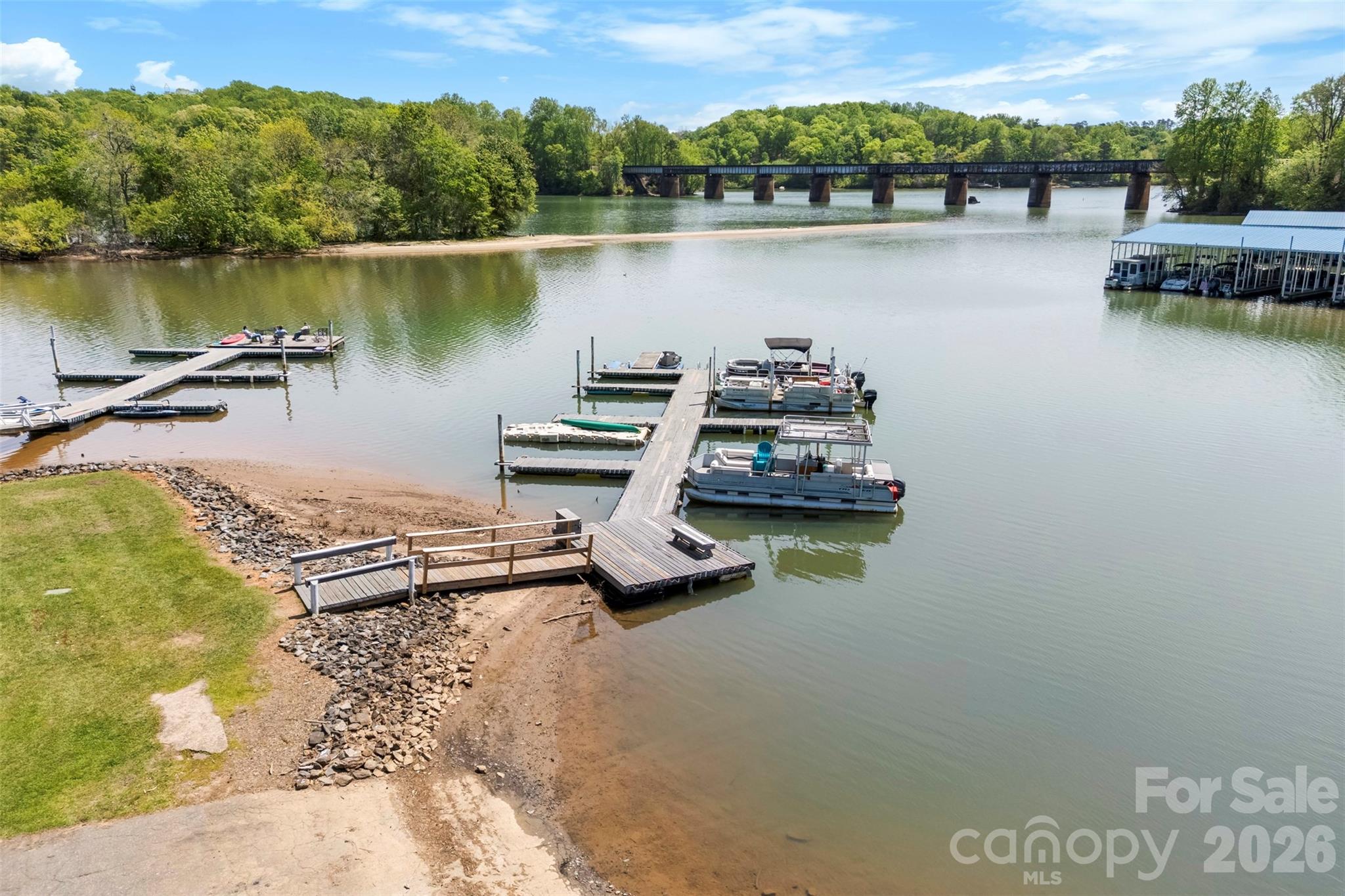 Wake up to water views and end your day on the deck in this inviting Belmont townhouse with a rare deeded boat slip—your gateway to a true waterfront lifestyle. Whether it's boating, fishing, or simply soaking in the peaceful surroundings, this home delivers. Inside, you'll find fresh paint, durable LVP flooring throughout, newer appliances, and touches of original character that add warmth and charm. Enjoy a private fenced backyard for relaxing evenings and a front porch with a view that never gets old. Nestled in a quiet community just minutes from downtown Belmont, Charlotte, and the airport—this is easy living with a lifestyle upgrade.