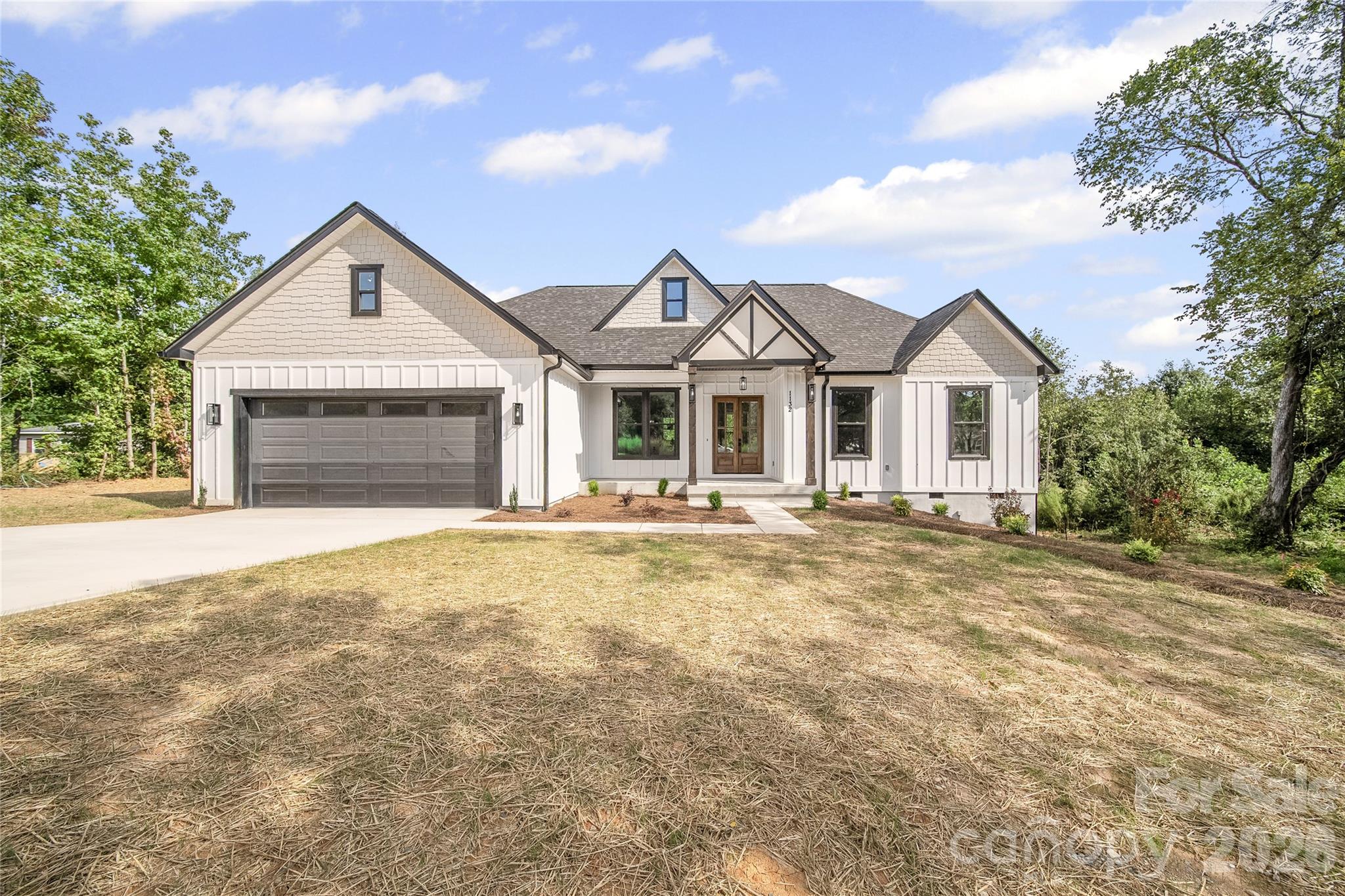 Welcome to this beautifully crafted custom-built home where modern luxury meets peaceful country living. Nestled on a spacious 1-acre lot, this stunning 4-bedroom, 2.5-bath home offers the perfect blend of quality craftsmanship, thoughtful design, and everyday comfort.

Step inside to an open-concept floor plan filled with natural light, creating a warm and inviting atmosphere. The spacious living room features a floor-to-ceiling tiled electric fireplace, serving as the perfect centerpiece for gathering with family and friends. The gourmet kitchen is designed to impress with custom cabinetry, quartz countertops, premium finishes, and a functional layout ideal for entertaining or daily living.

The private primary suite offers a relaxing retreat with a spa-inspired bathroom and generous walk-in closet, while the additional bedrooms provide flexibility for guests, a home office, or growing families.

Enjoy quiet mornings with coffee or unwind in the evenings on the oversized covered back porch overlooking the peaceful backyard. With plenty of space to relax, entertain, or simply enjoy nature, this outdoor living area extends the home's exceptional livability.

Built with attention to detail and quality finishes throughout, this move-in-ready home offers the peace of mind that comes with new construction while providing the perfect balance of luxury, functionality, and privacy. Conveniently located with easy access to Kannapolis, Concord, and Charlotte, this is a rare opportunity to own a custom home that truly has it all.