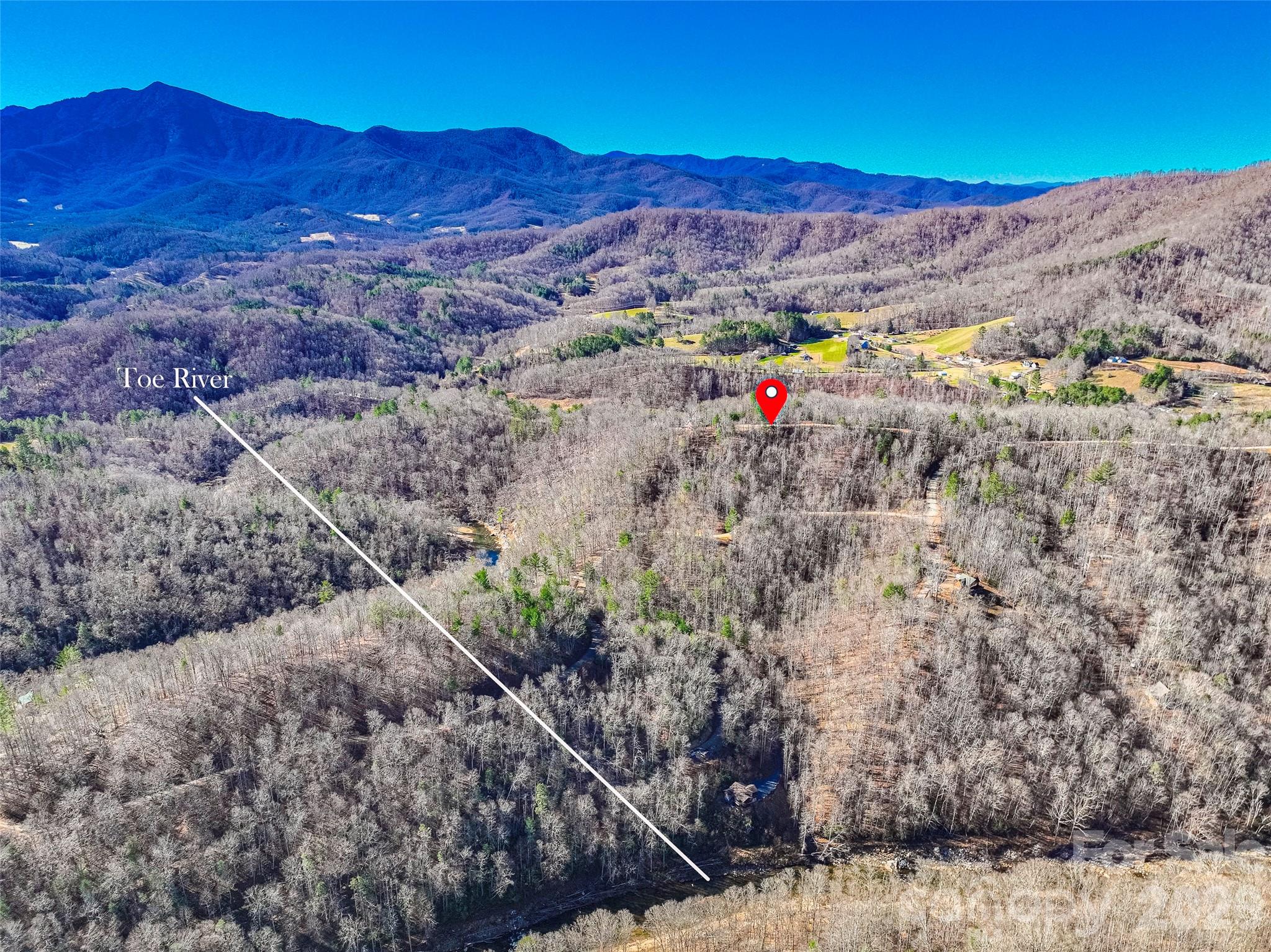 Imagine waking up to mountain views on your own piece of paradise in the private, secure, gated community of River Crest. Lot #10 is a buildable 1.67 acre lot that would require minimal grading making it easy to build your custom home. The lot features a gentle slope, starting level at the road frontage, making it easy to build your custom home. Easy access off a state maintained road with excellent internal roads throughout the community & underground utilities already in place. An exclusive common area joins the beautiful Toe River. Spend your days relaxing, trout fishing, tubing, or kayaking right from your neighborhood. Located 9.2 miles to downtown Burnsville, 1 hr to Asheville.  Adventure awaits at nearby destinations like the Dark Sky Observatory, Appalachian Trail, Mount Mitchell State Park & Blue Ridge Parkway. Don't just buy land—buy a lifestyle. Come sit back, relax, and enjoy the beauty surrounding you in the mountains of WNC! Showings by Appointment Only. Gate Code needed for access