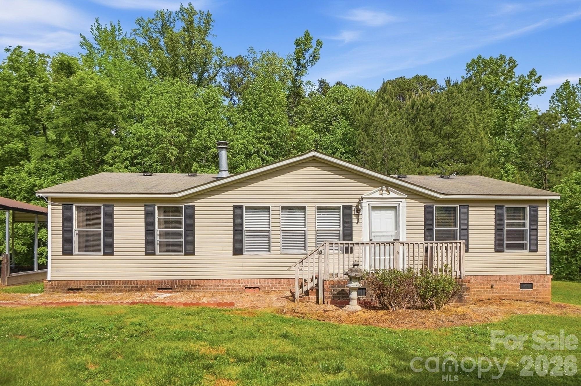 WELCOME to quiet COUNTRY LIVING on 8.29 ACRES! Home with 28'x60' GARAGE/SHOP, second detached garage, and multiple carports, buildings, and lean-tos. All in the Jesse Carson School District! This 3 bd/2 ba, 1285 SqFt home is ready for you to update however you choose-- the sellers are offering a $5,000 BUYER INCENTIVE to replace the flooring, paint the walls, or do any updates you wish. Behind the home, you'll find a private covered porch which makes a great area for sitting, relaxing, grilling, etc. You'll also find a conveniently located 16'x16' storage building with large lean-tos on each side. Next to the home, a 3-bay carport, including an RV-height bay in the center. Don't miss the lovely peach and pecan trees in the front yard!

The 2020-built GARAGE/SHOP measures 1695 SqFt and comes with all the bells and whistles!! Heated and cooled for projects year-round in comfort. Wired for 110 and 220v, including 3 plugs along the back wall for welders. Additional plugs all around the top of the walls for hanging/displaying neon lights or other signs that need power. 11,000 lb Advantage 4-Post Lift (SS11000WD Series). Kobalt 60-gal Air Compressor. 3 tall garage doors with Liftmaster ultra quiet openers. Maintenance-free epoxy floors. Attic storage above. Bonus-- the 70" Samsung TV and Whirlpool refrigerator both remain!

On this property you'll find several other buildings. A second 963 SqFt detached garage/workshop with 3 bays and a lean-to off the back. This structure was built with wood harvested from the land when it was cleared and was milled on site. There's another metal 2-car carport farther down the driveway for additional vehicle storage. And finally, the "log cabin" structure out front (11'x12') originally built as a chicken coop. Could be used again as a small stable for a hobby farm, or a tractor shed, or would make a great "playhouse."

More than half of this property remains wooded and untouched. Mature hardwoods peppered with pines lead back to a small creek and round out this beautiful rural setting. ***LENDER CREDIT Up to $4,350 if financed through The Knorr Group of ALCOVA Mortgage.