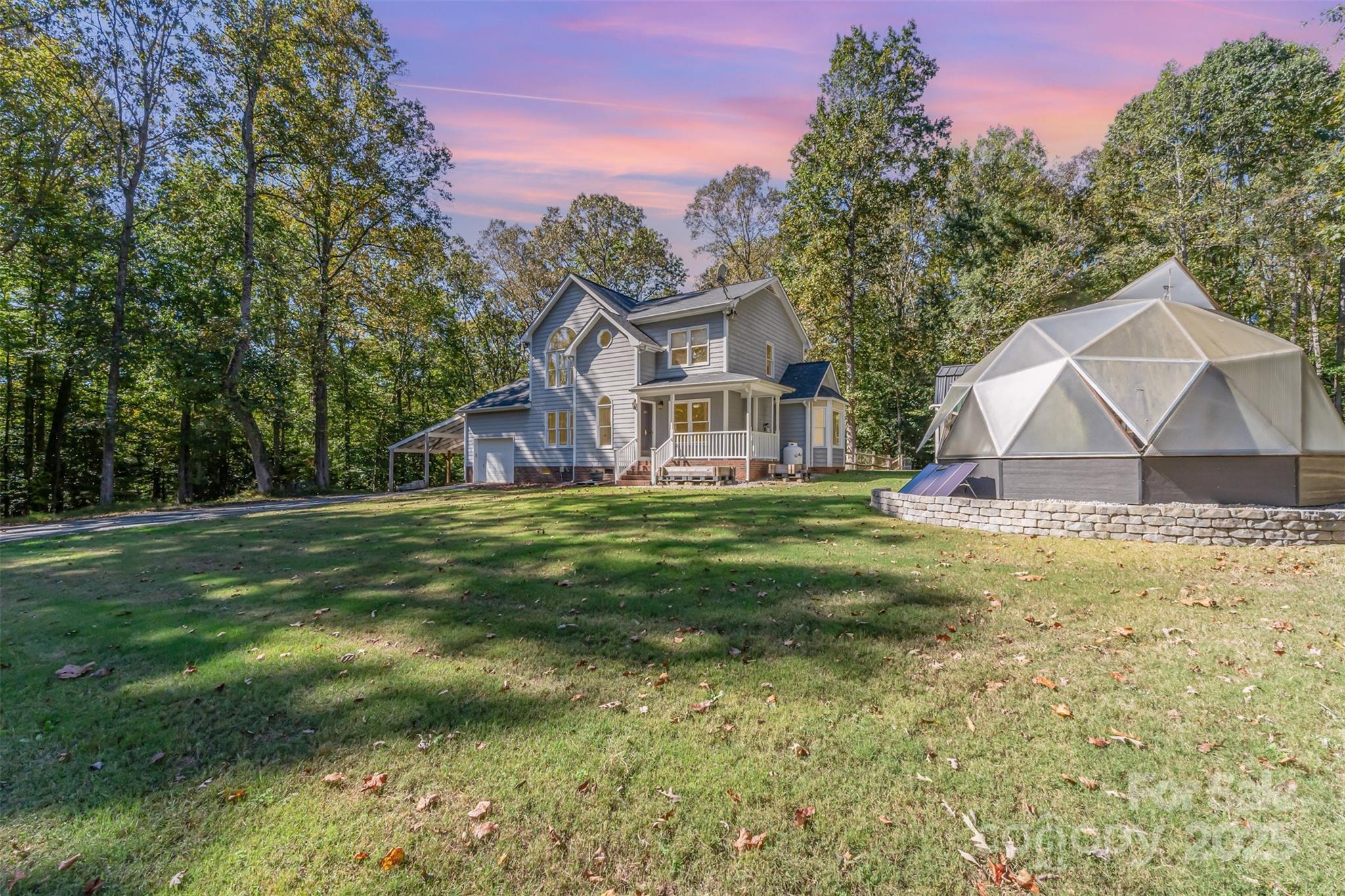 Your own private estate on over 10 acres awaits! Nestled at the end of a long, tree-lined drive, this peaceful two-story home offers total privacy with no HOA. Surrounded by nature, it’s the perfect retreat for anyone seeking space and serenity. Enjoy a wraparound front porch, fenced backyard area for pets, and both a large single-car garage and attached two-car carport for plenty of parking and storage. Inside, the home has been freshly painted throughout and features refinished kitchen counters and painted cabinetry for a bright, updated look. The main level includes a spacious bonus room ideal for a home office, craft room, or game space, while upstairs you’ll find all bedrooms with hardwood floors in most areas. Additional highlights include a newer roof (2020) and a recently added greenhouse, perfect for gardeners. Take in the quiet surroundings, listen to the creek, and enjoy the peace this property provides—your secluded getaway just minutes from town!